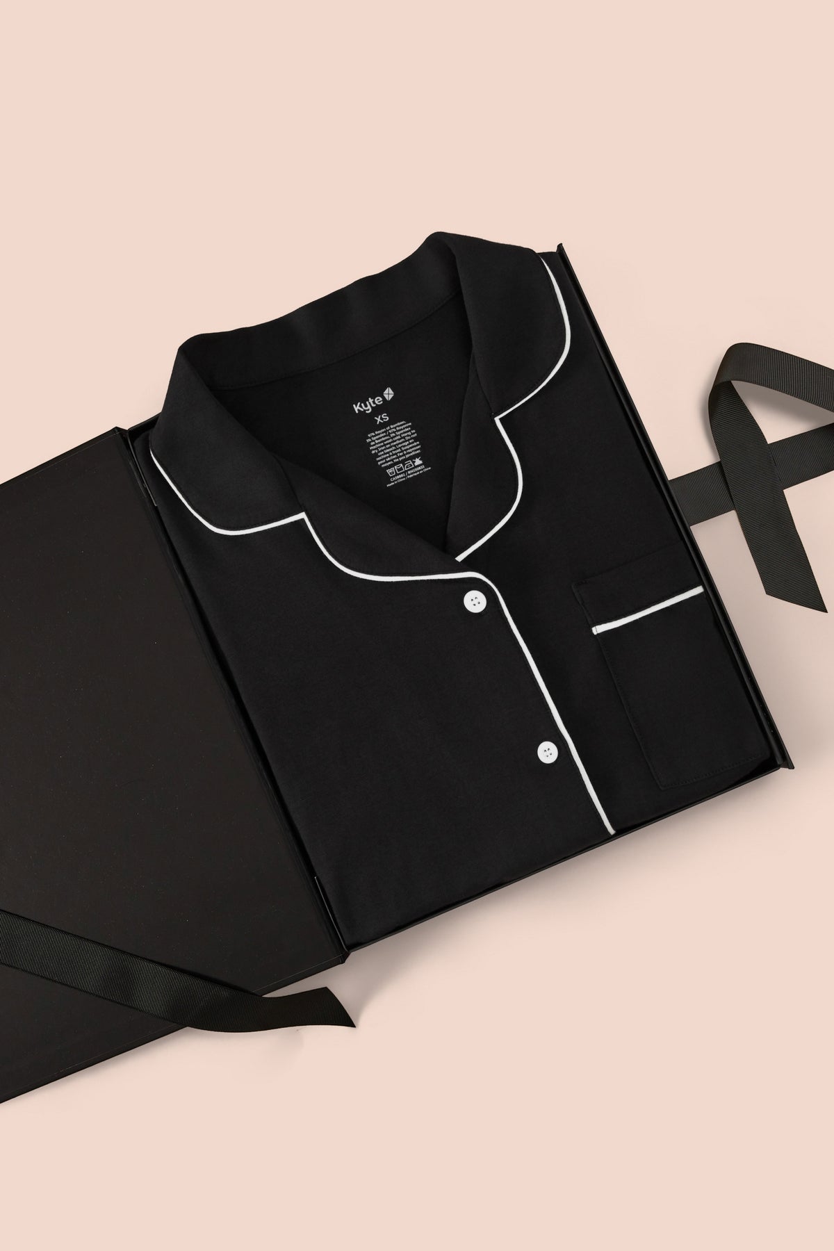 Long-Sleeved Women's Pajama Set in Midnight with Cloud Trim packed in a box on a beige background
