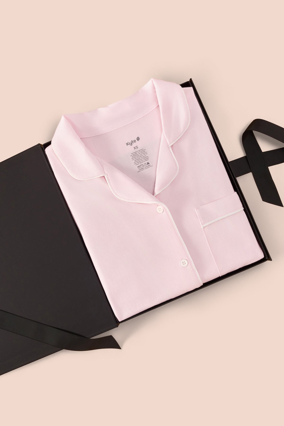 Women’s Short Sleeve Pajama Set in Sakura with Cloud Trim print packed in a box on a beige background