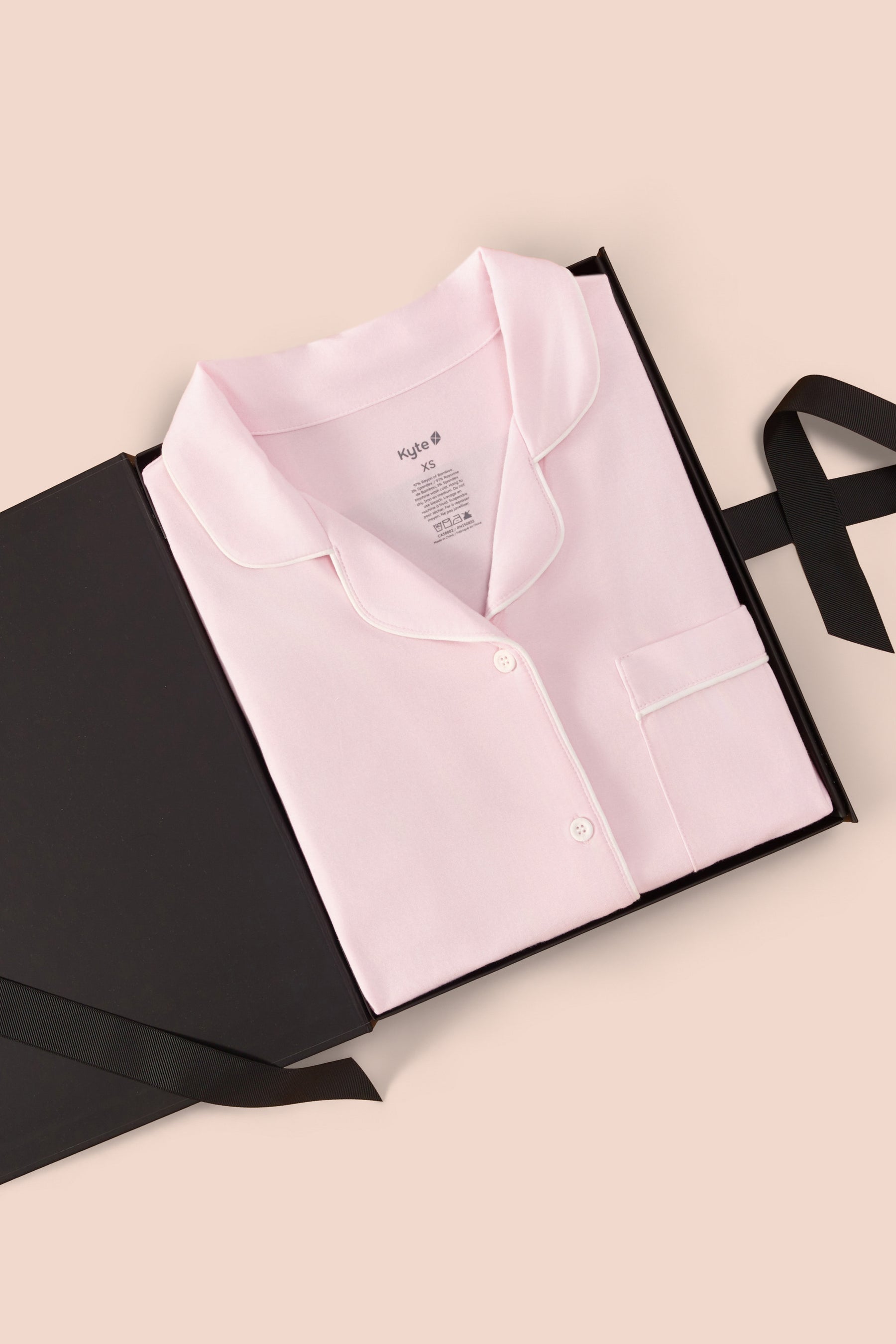 Women’s Short Sleeve Pajama Set in Sakura with Cloud Trim print packed in a box on a beige background