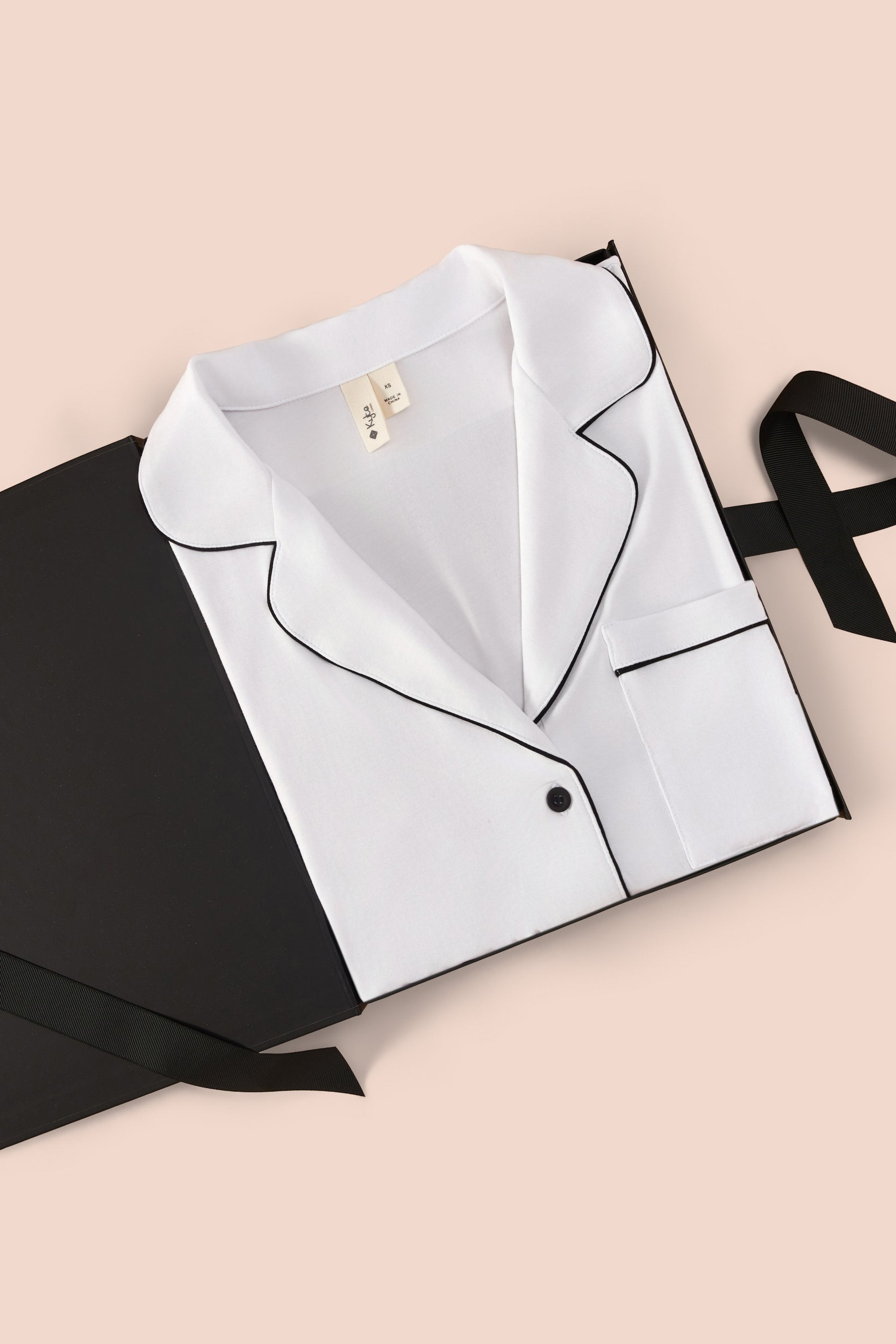 Women's Long Sleeve Pajama Set in Snow with Midnight Trim packed in a box on a beige background