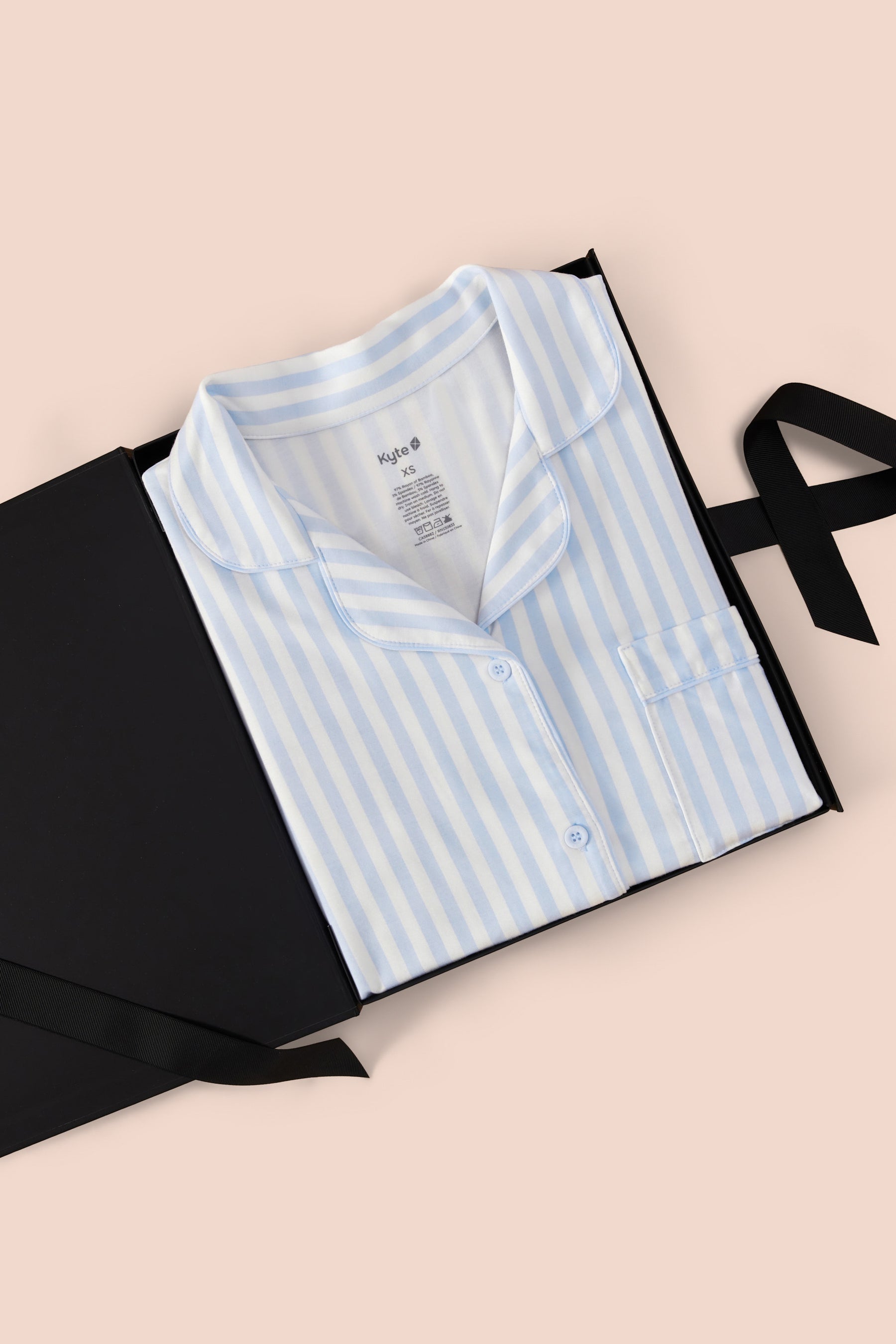 Long-Sleeved Women's Pajama Set in Small Mist Stripe with Cloud Trim packed in a box on a beige background