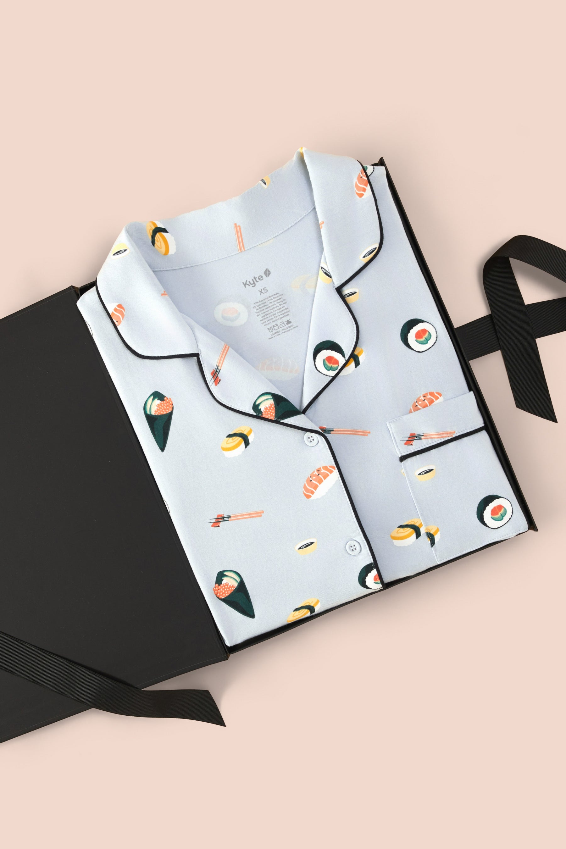 Women's Short Sleeve Pajama Set in Ice Sushi print packed in a box on a beige background