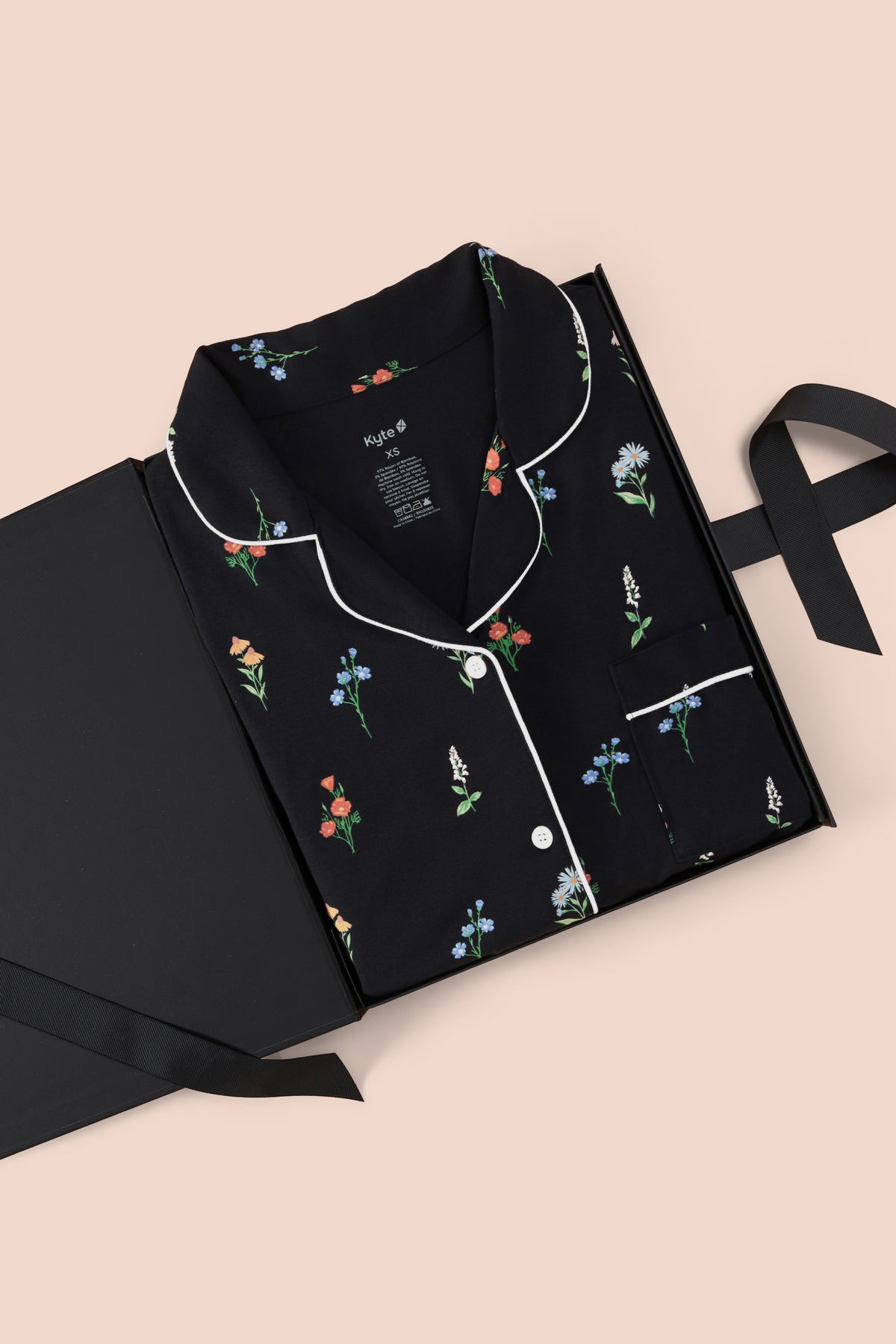 Women's Short Sleeve Cropped Pajama Set in Midnight Wildflower print packed in a box on a beige background
