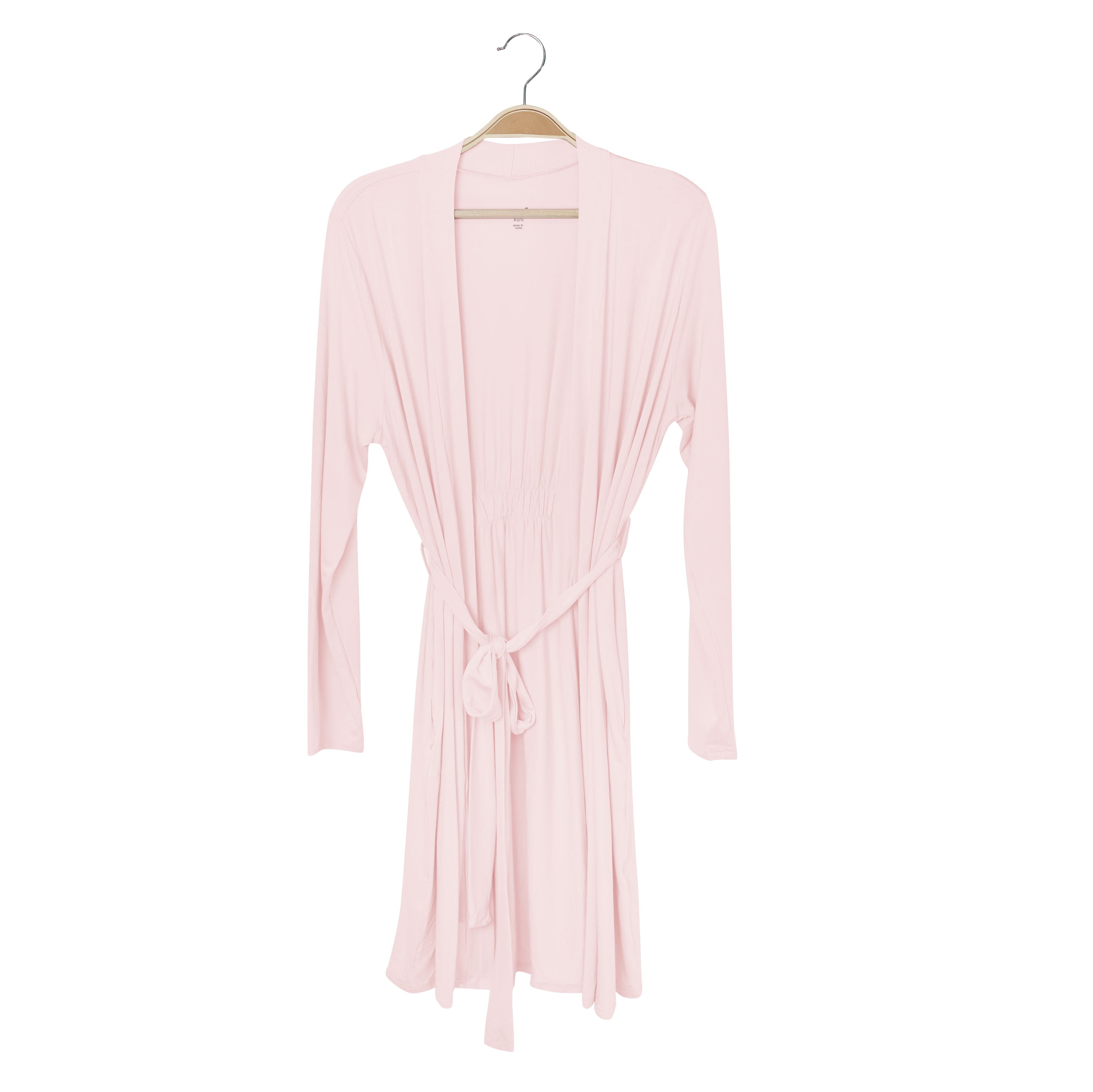 Pink robe on a hanger against a white background