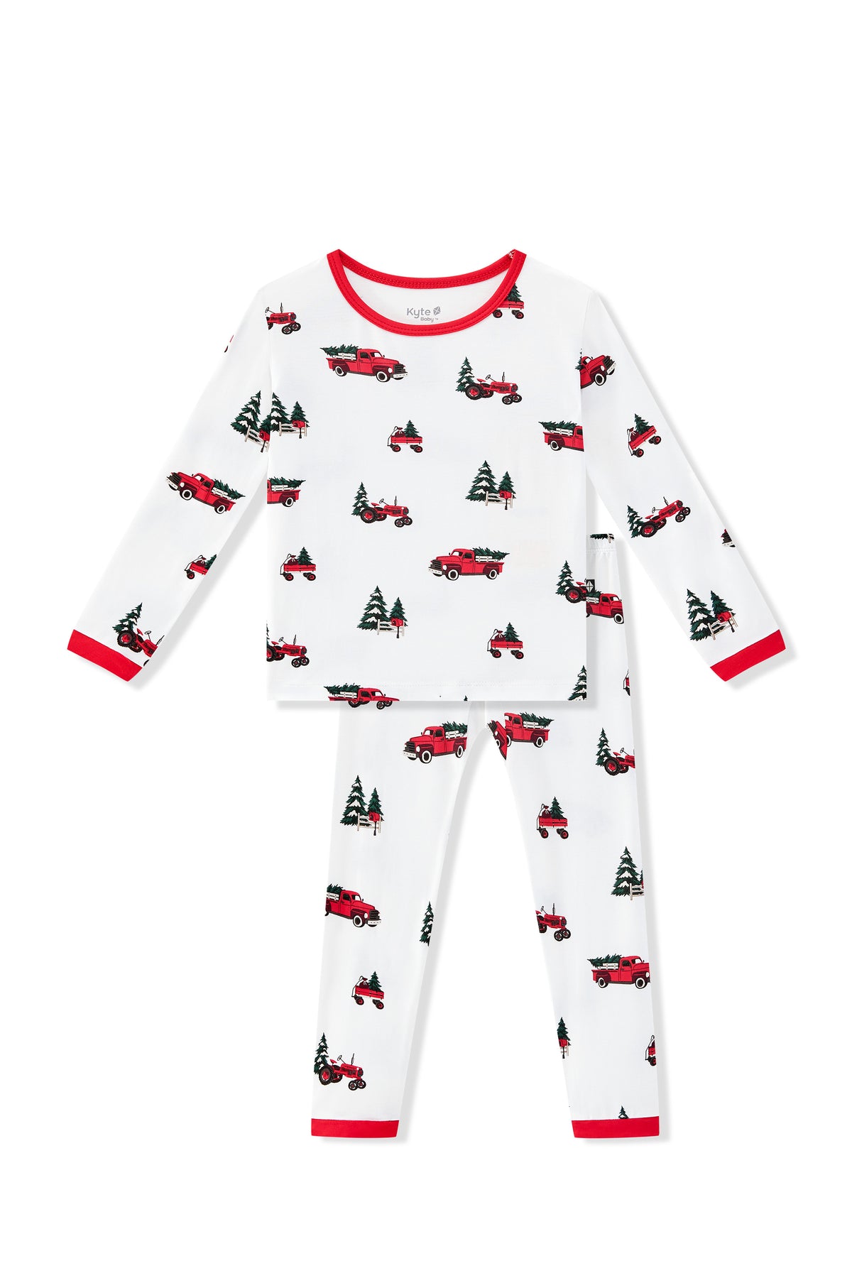 A two-piece children's pajama set featuring a white long-sleeve top and matching pants with a repeating pattern of red pickup trucks and green Christmas trees, finished with red trim at the collar, cuffs, and hem.