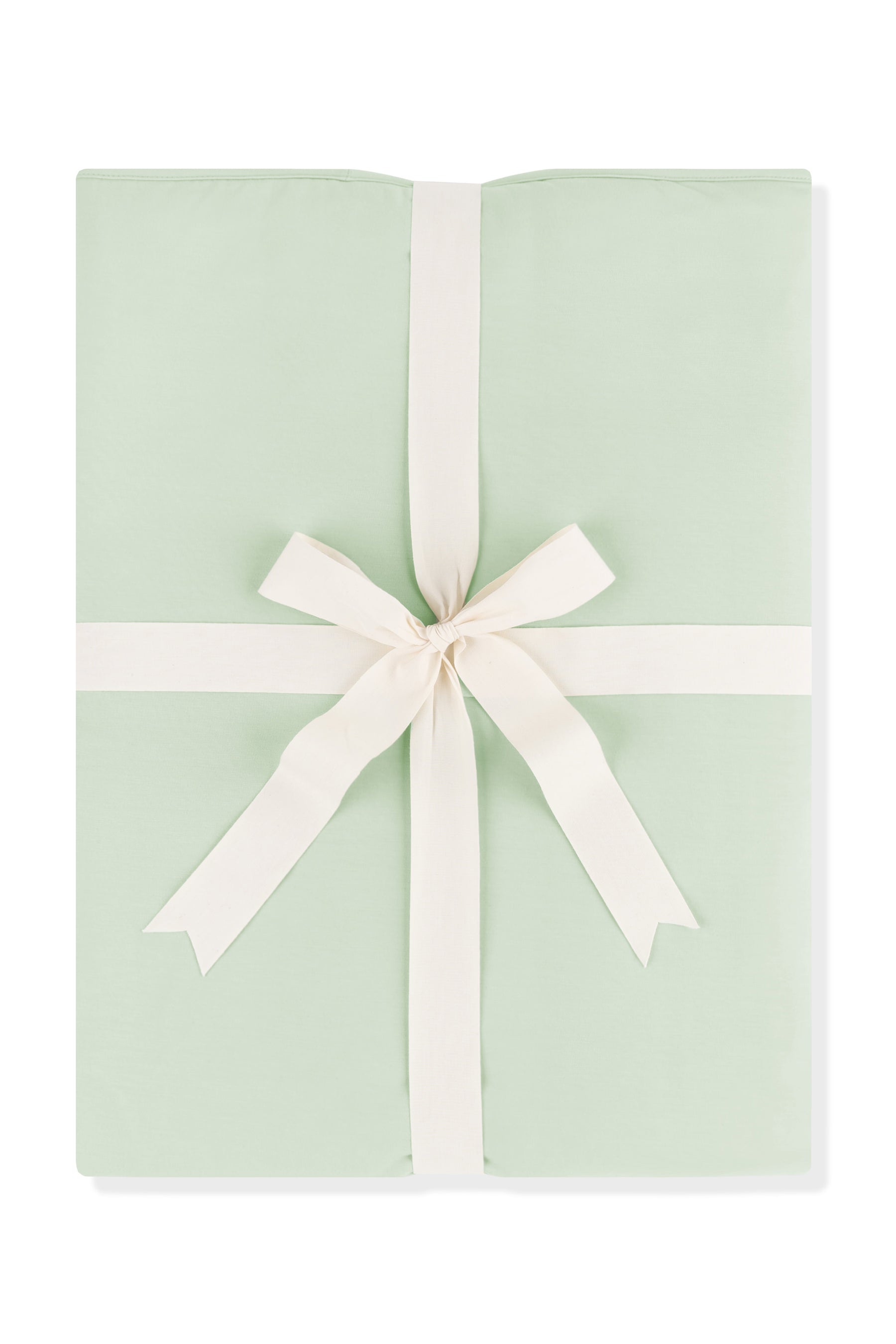 Youth Blanket in Basil 1.0 shown wrapped in its packaging tied with a linen bow