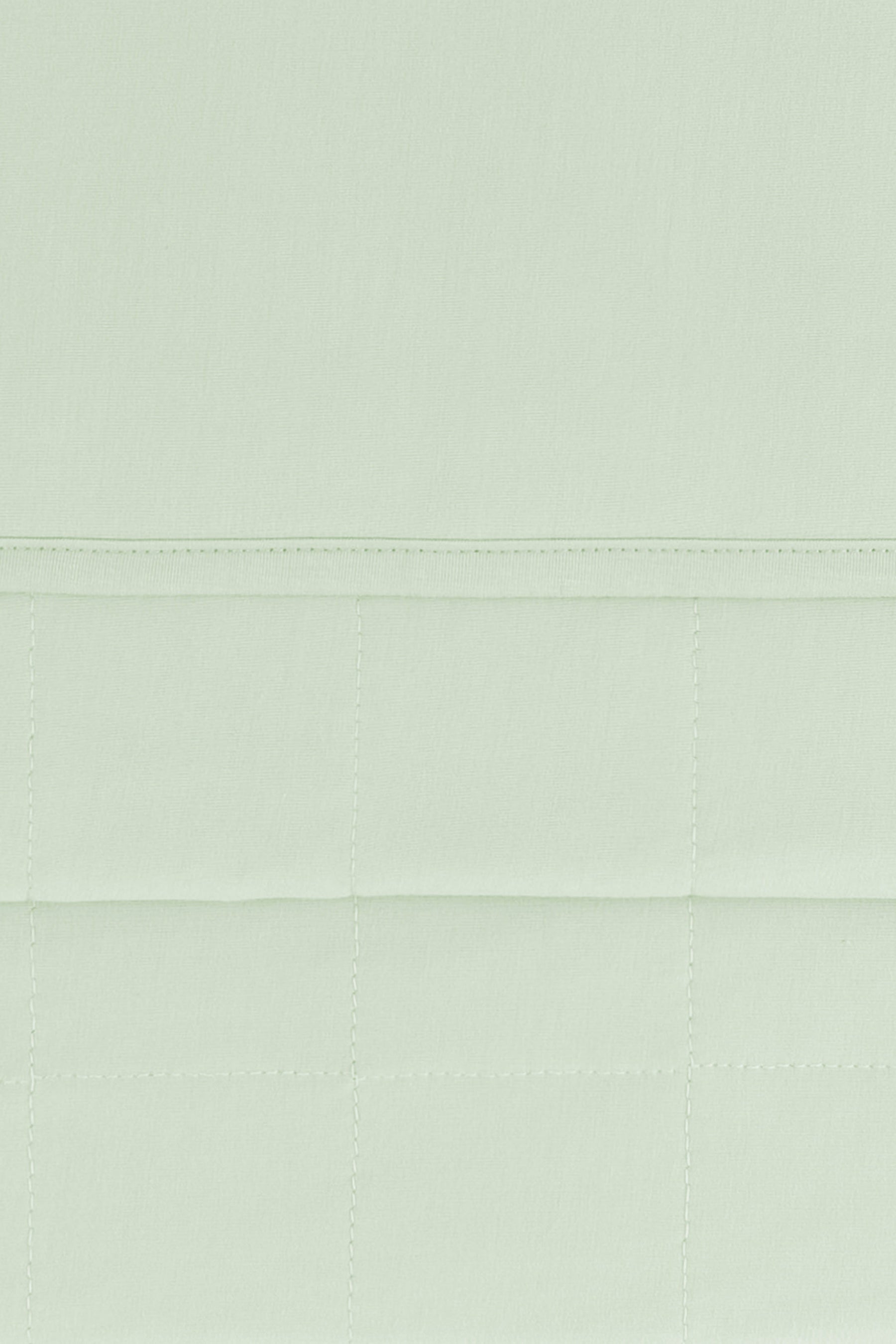 Close up of the Youth Blanket in Basil 1.0 showing the quilted backing and smooth top layer