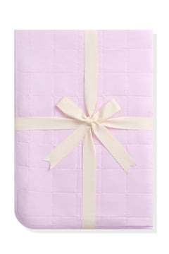 Youth Blanket in Thistle 1.0 shown in its packaging tied in a linen bow