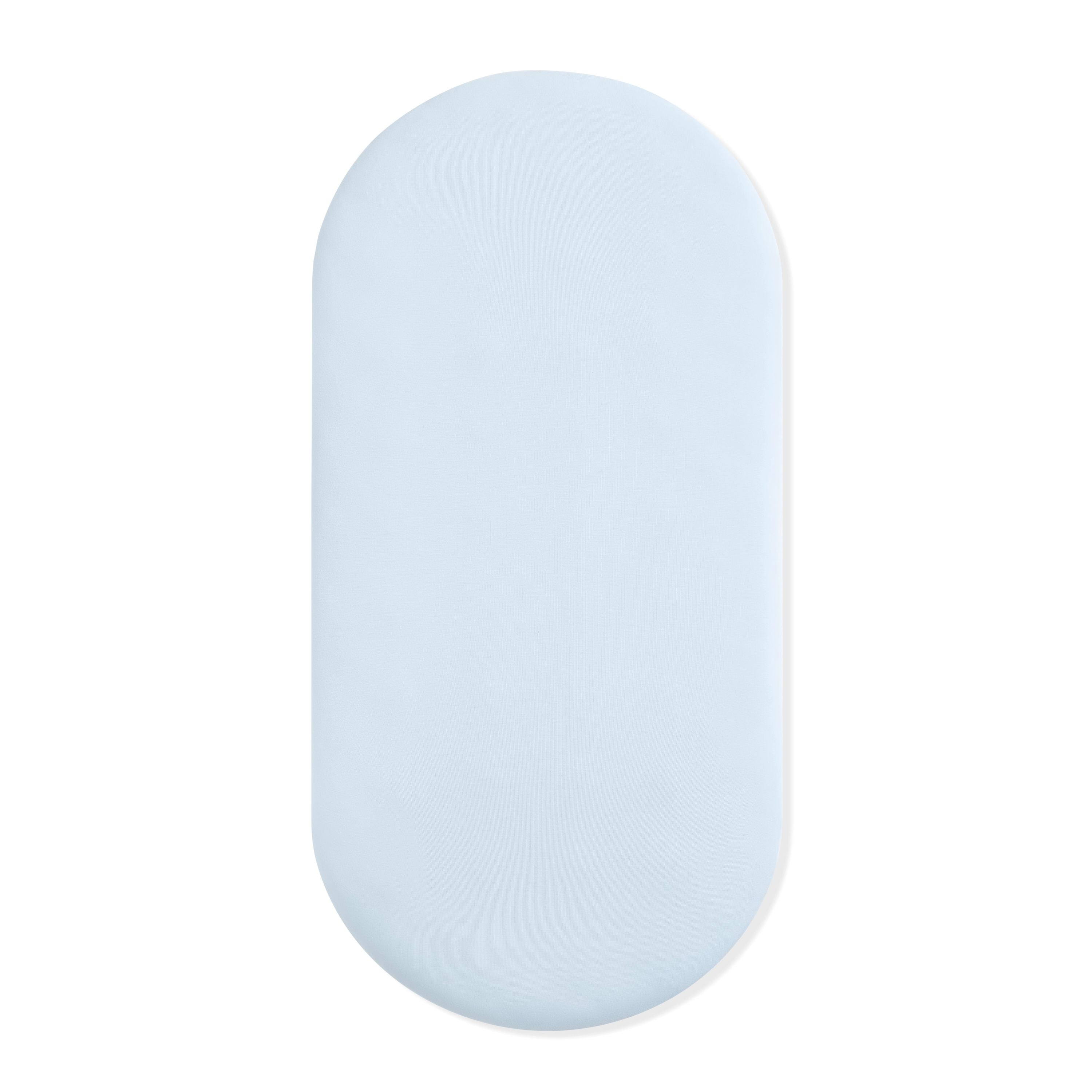 Oval Bassinet Sheet in Breeze shown on a bassinet mattress