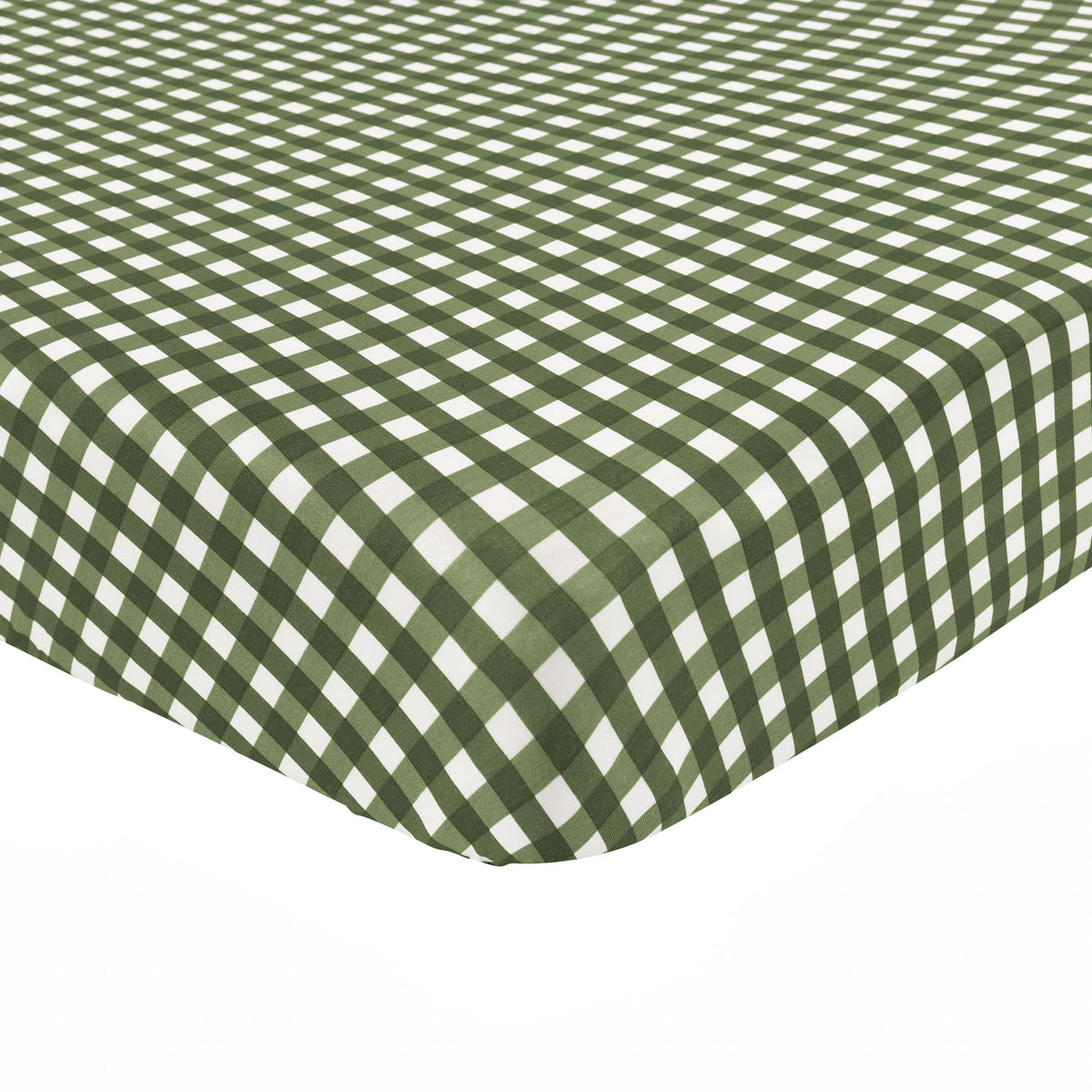 Corner of the Crib Sheet in Gingham Fir shown on a crib mattress