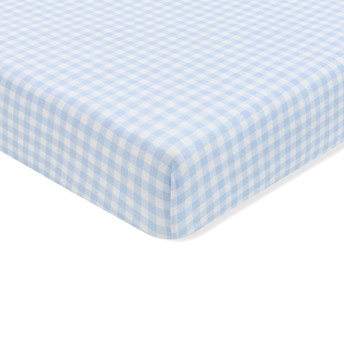 The corner of the Crib Sheet in Gingham Breeze shown on a crib mattress