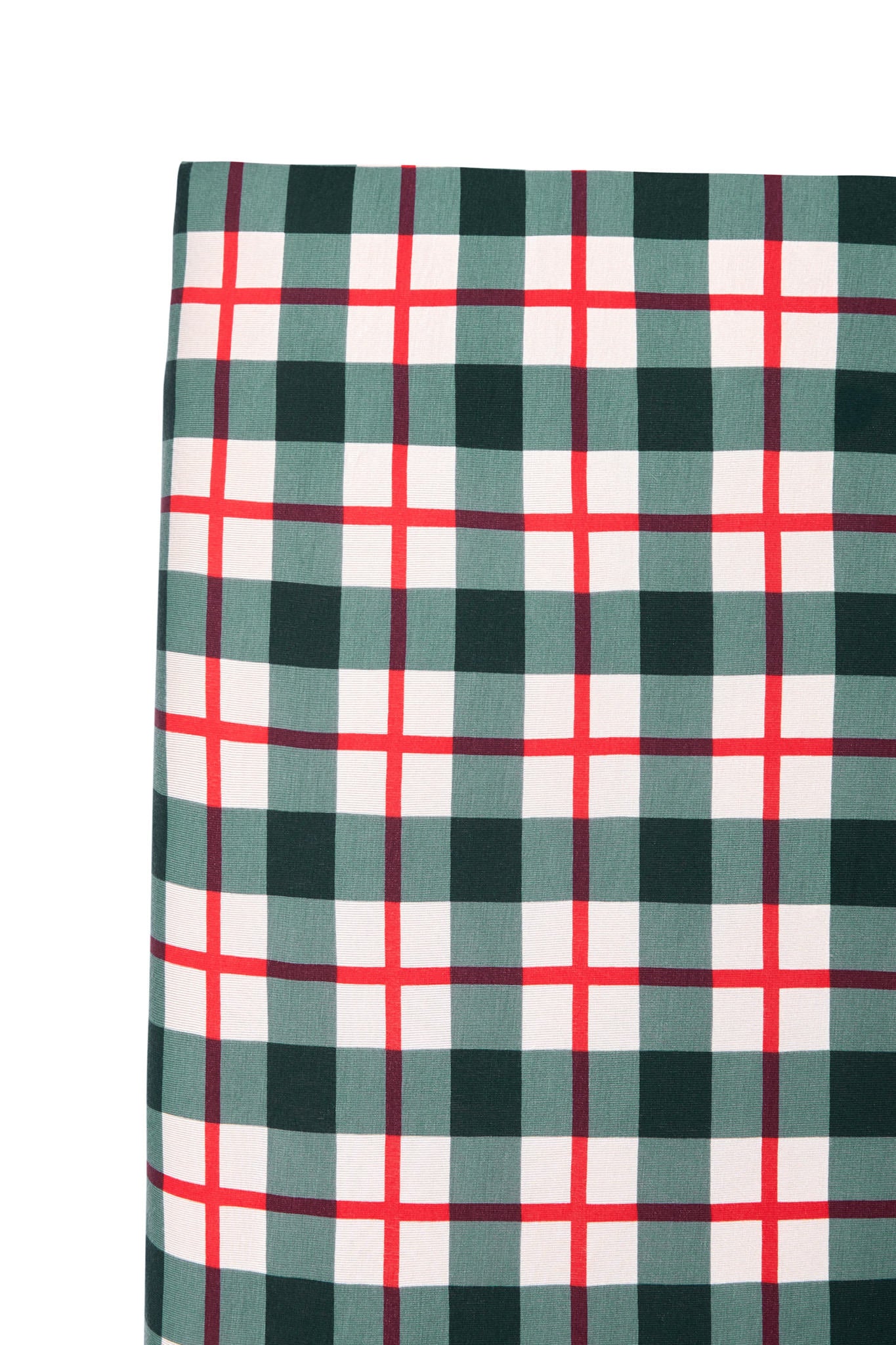 A close-up of a plaid fabric pattern with dark green, white, and red intersecting stripes, shown against a plain white background.