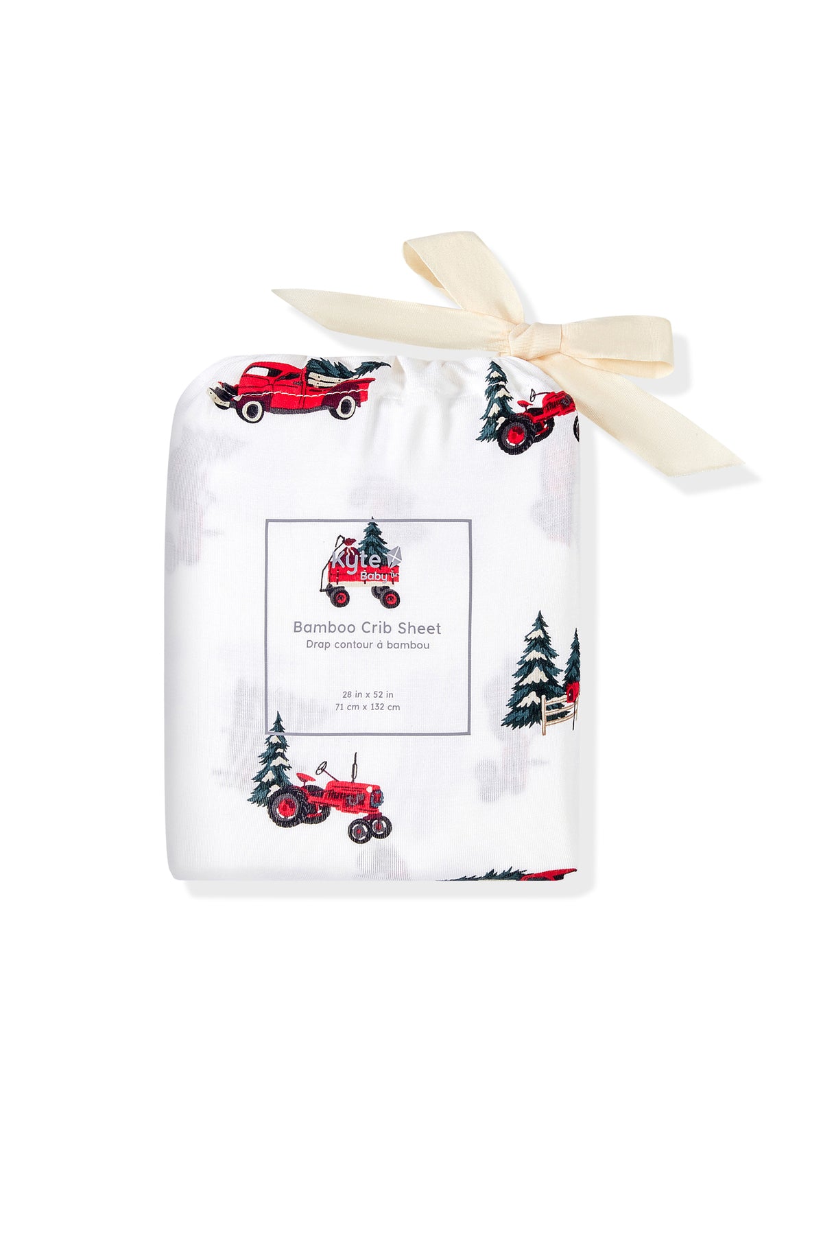 A packaged bamboo crib sheet with a red tractor and pine tree pattern, tied with a cream ribbon, on a white background.