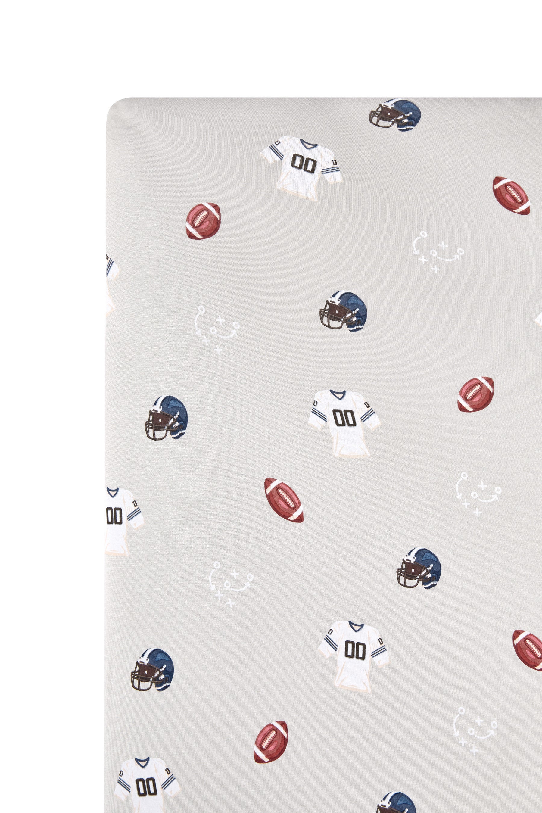 Close up of Crib Sheet in Vintage Football print on a white background
