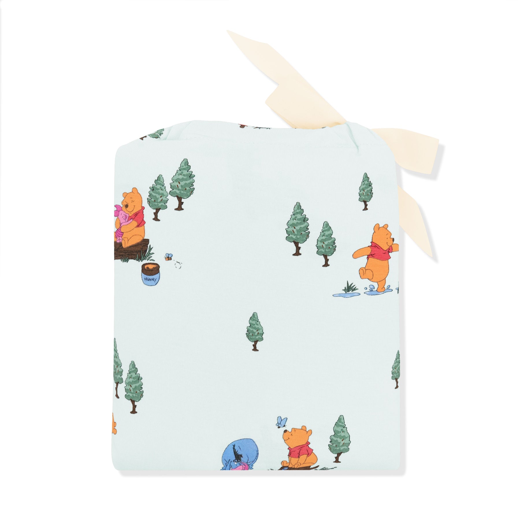Crib Sheet in Winnie the Pooh Hundred Acre Wood shown in its packaging