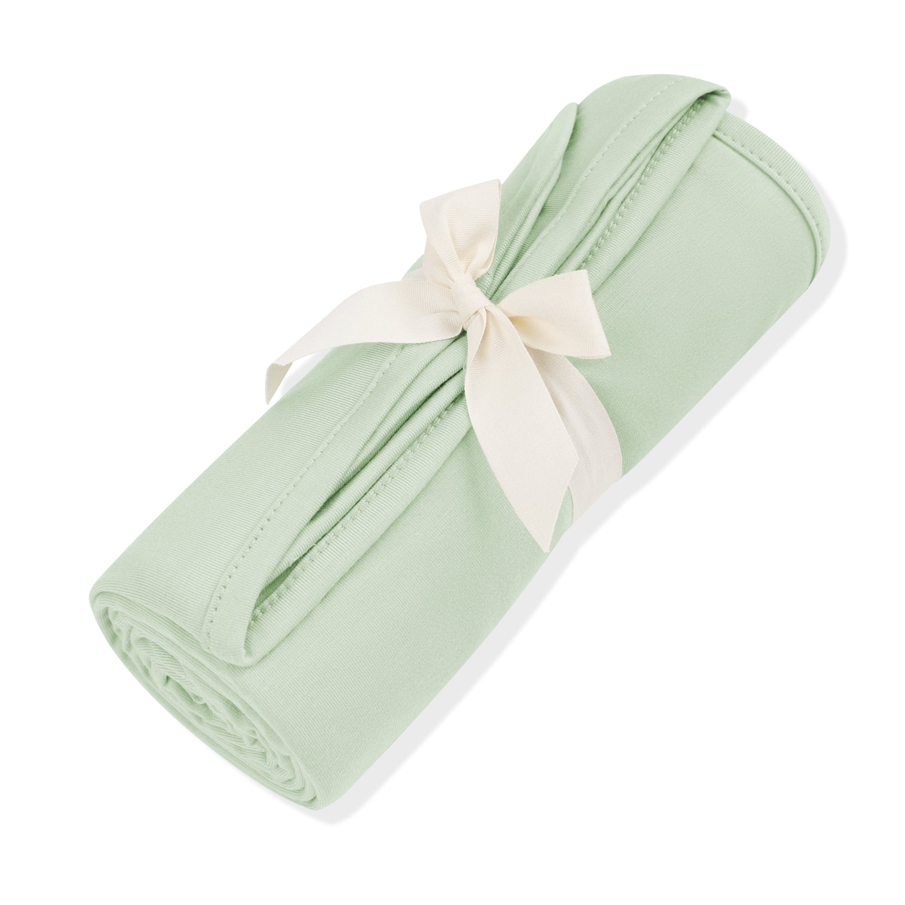 Swaddle Blanket in Basil shown rolled in its packaging wrapped in a linen bow