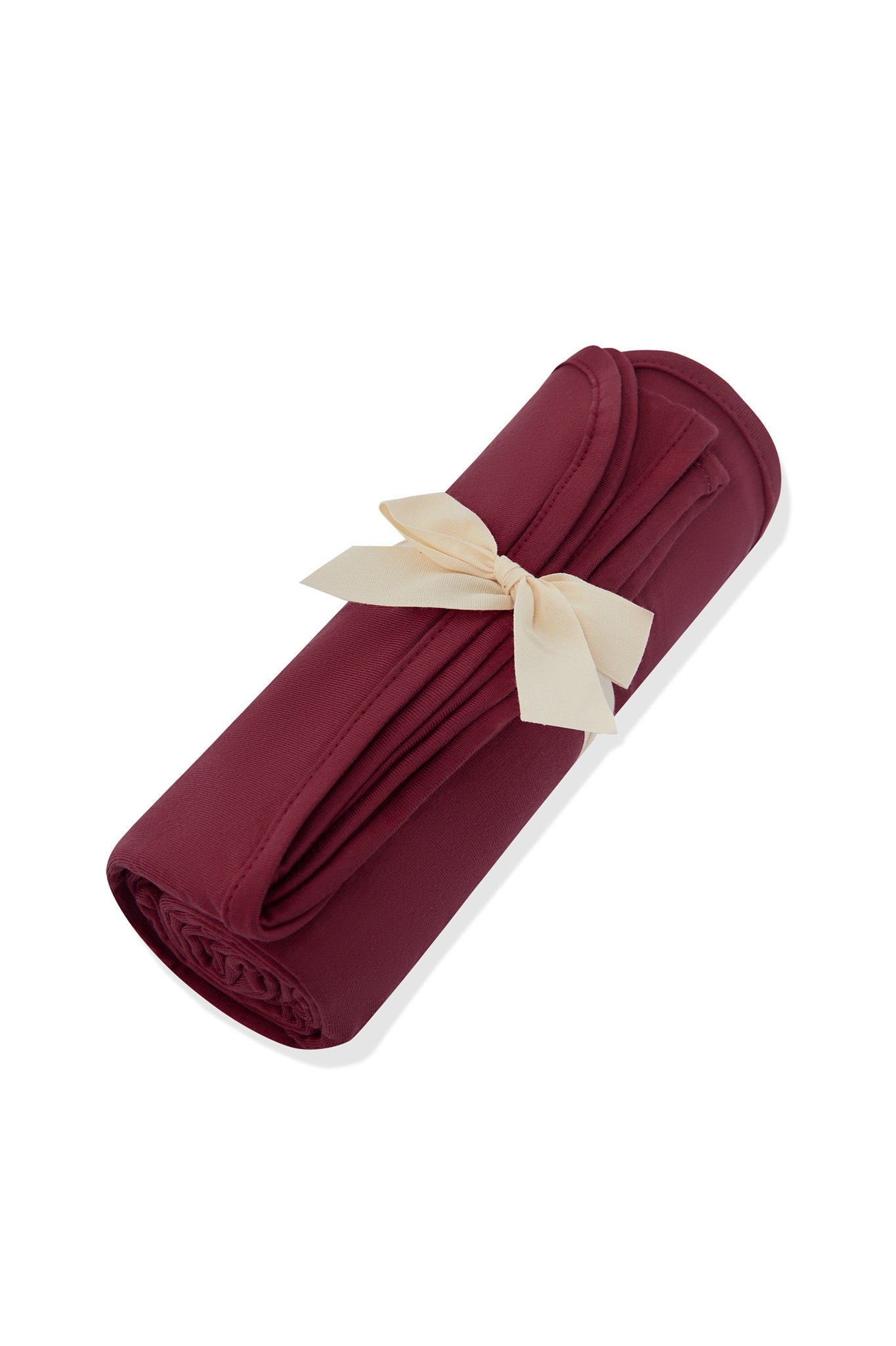 Swaddle Blanket in Burgundy rolled and tied with a ribbon on a white background