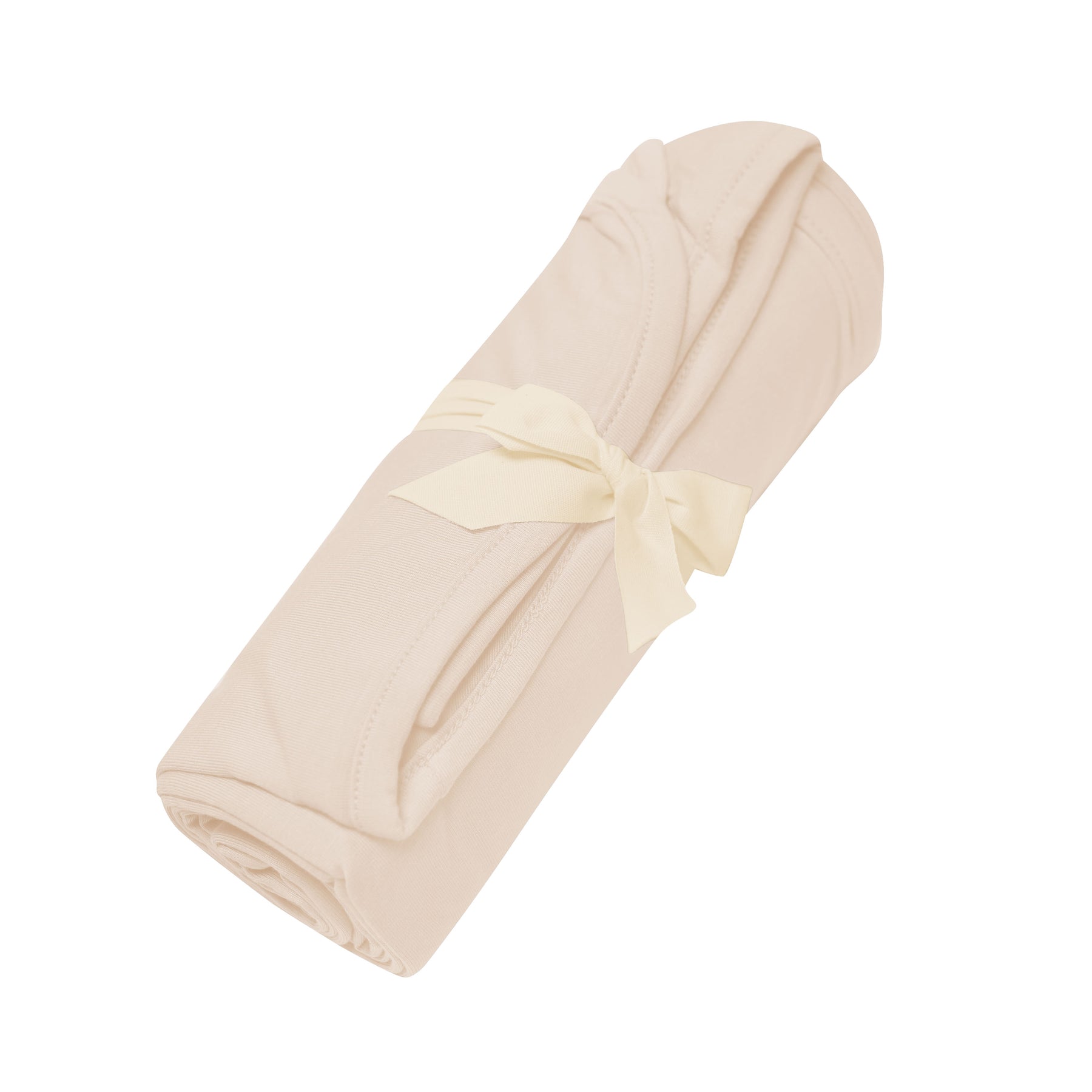Swaddle Blanket in Bisque shown rolled in its packaging