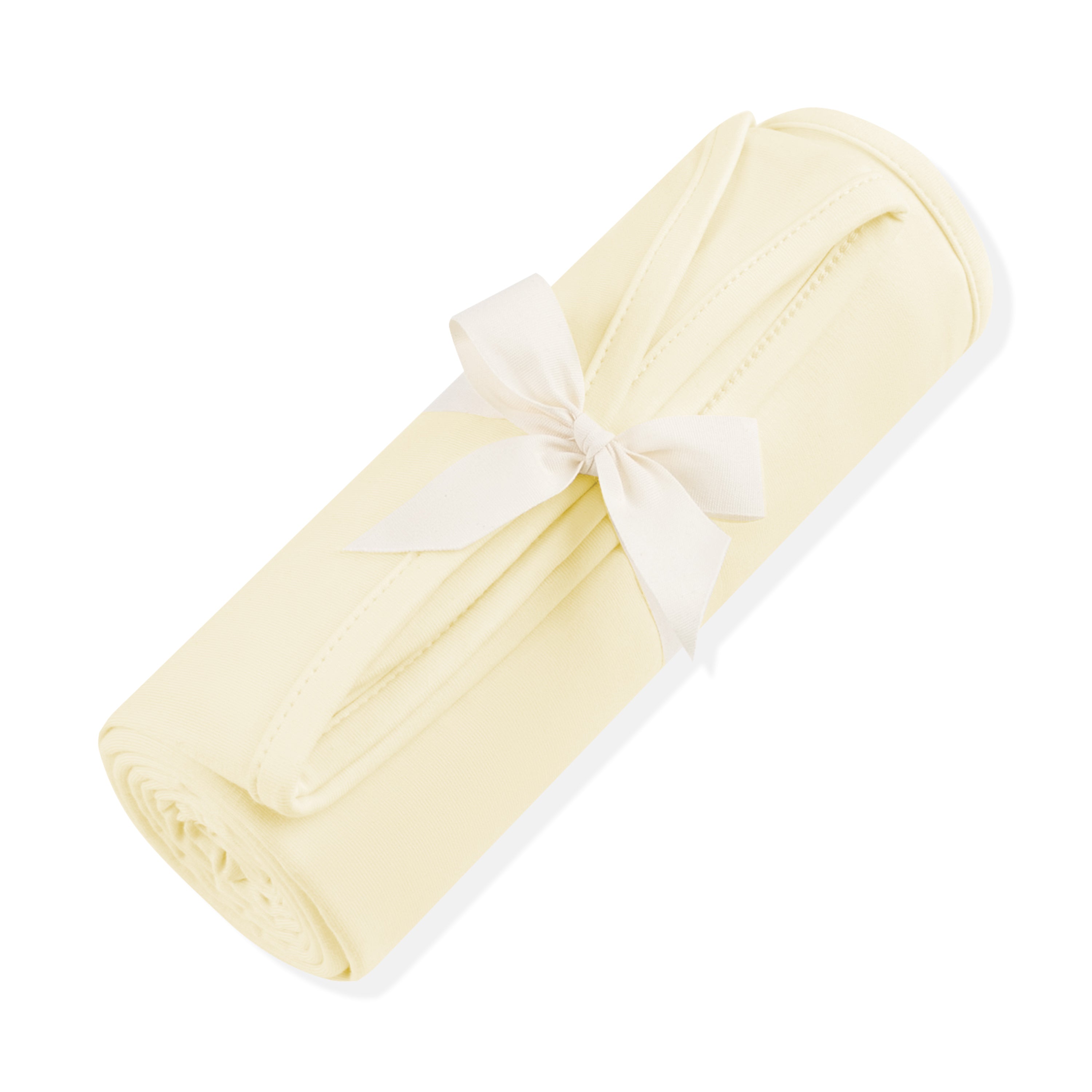 Swaddle Blanket in Chamomile shown rolled in its packaging tied with a linen bow