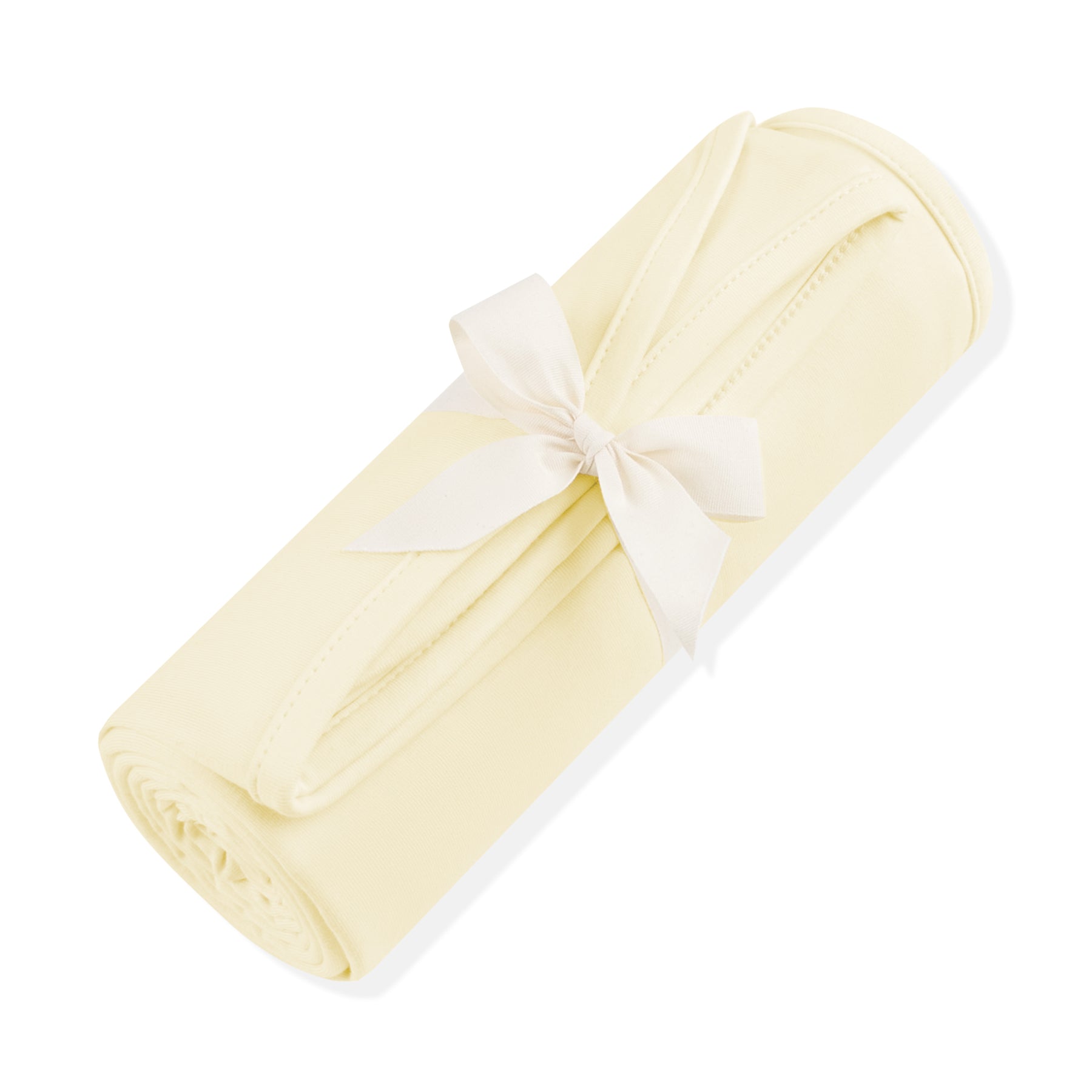 Swaddle Blanket in Chamomile shown rolled in its packaging tied with a linen bow
