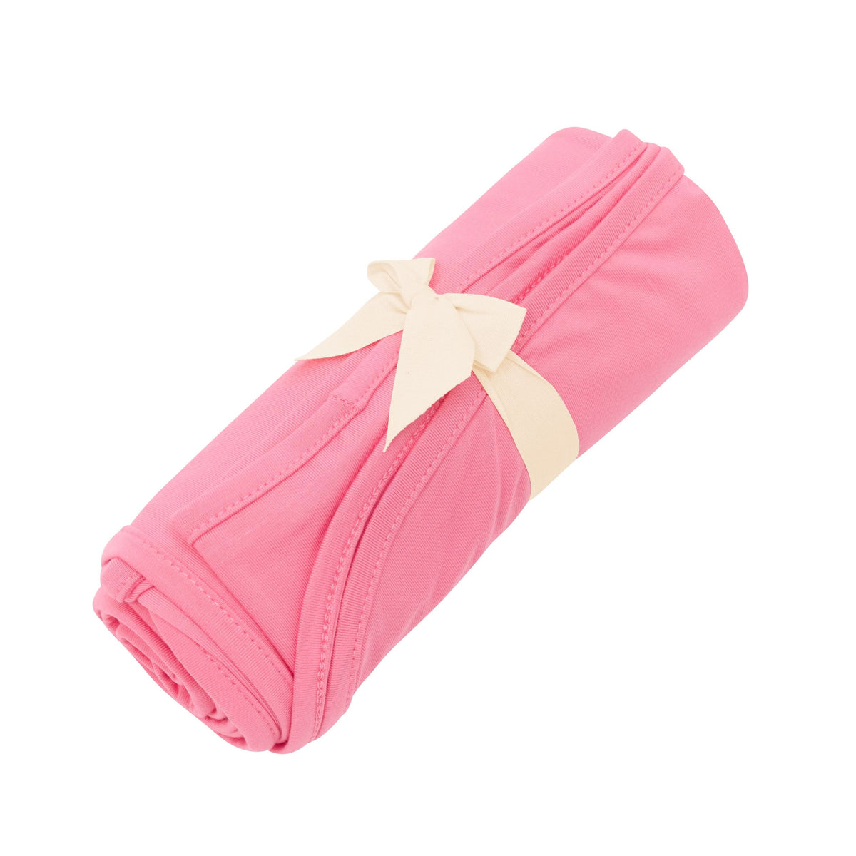 Kyte Baby Swaddle Blanket in Guava tied up with bow