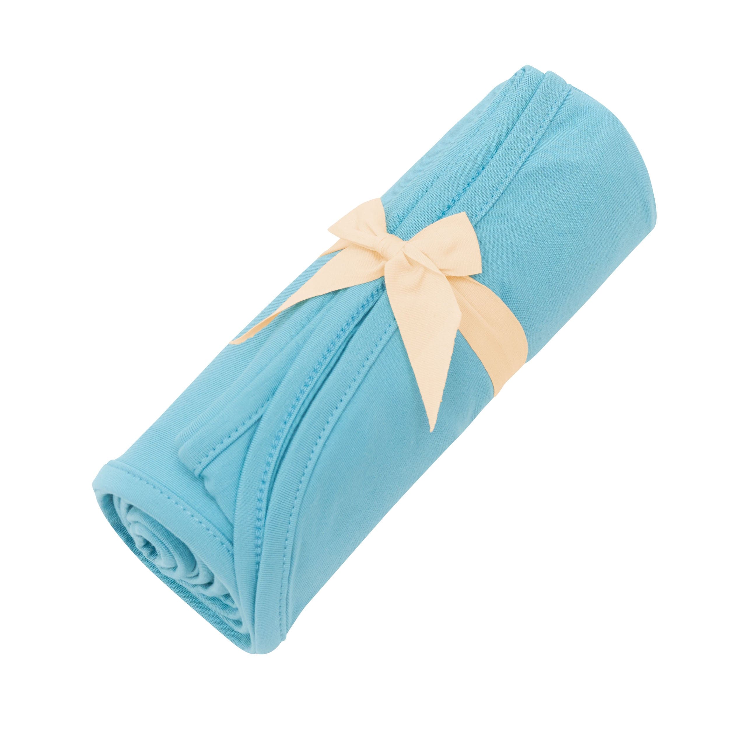 Kyte Baby Swaddle Blanket in Makai tied with bow