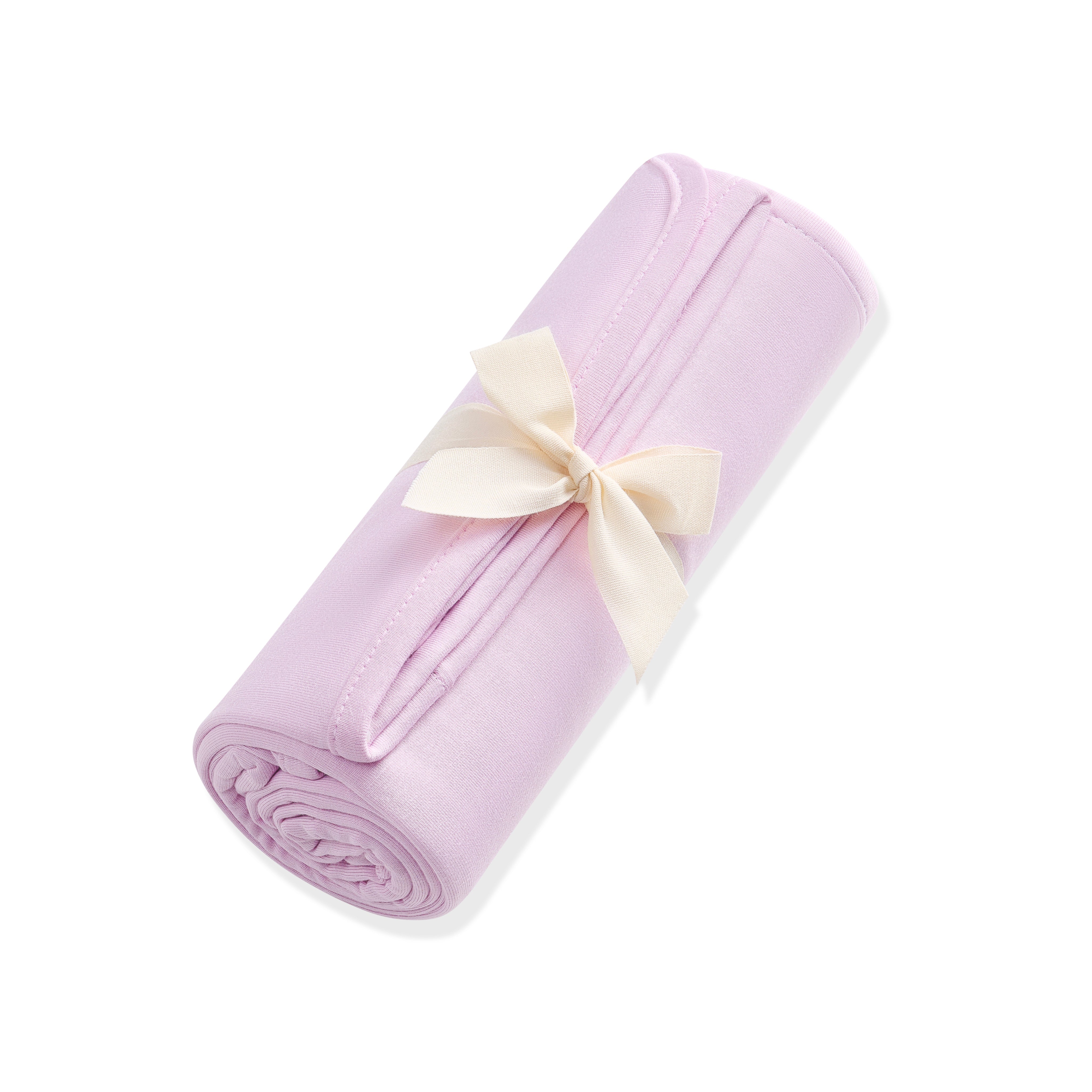 Rolled-up purple blanket with a cream bow on a white background