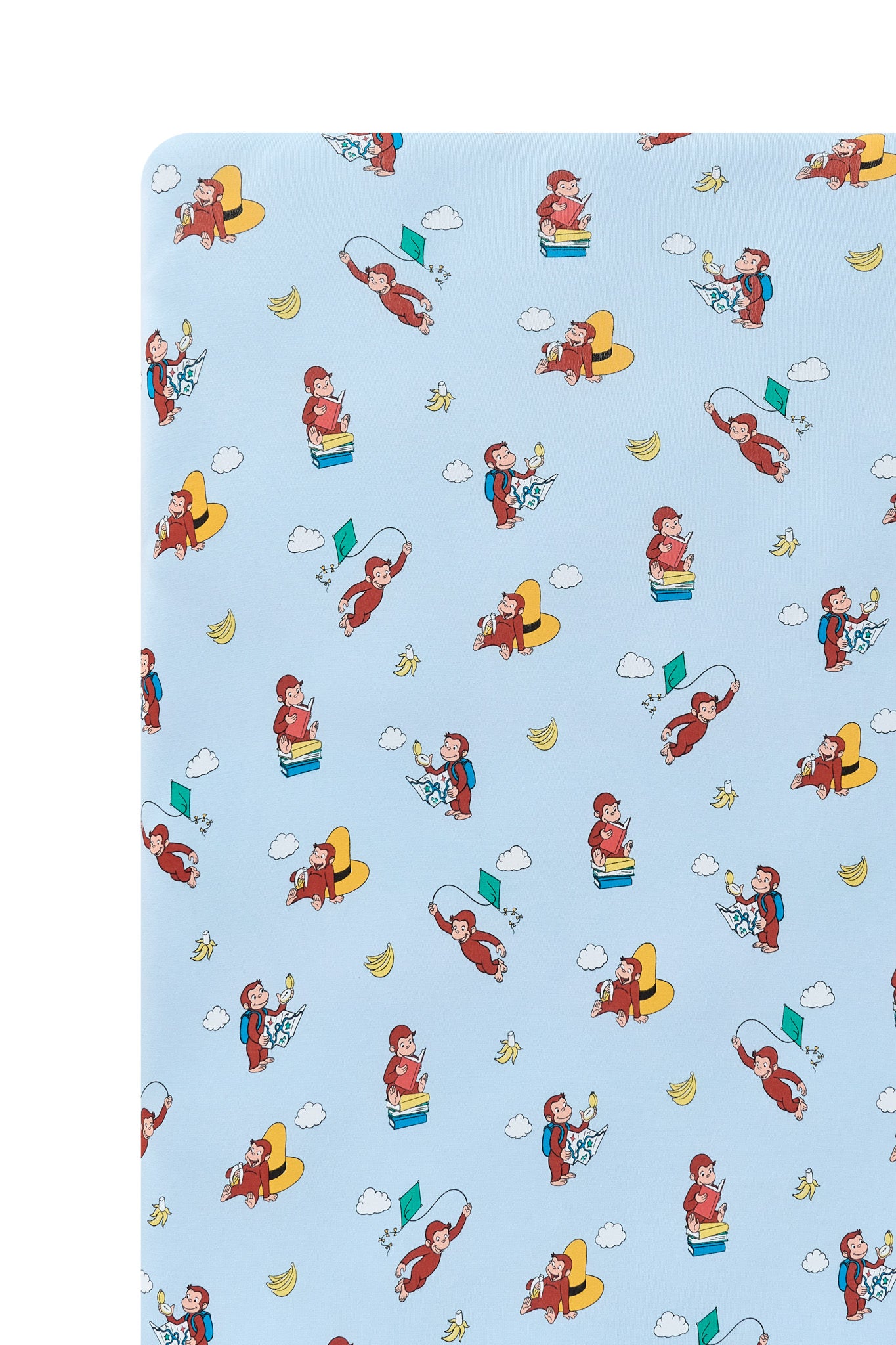 Close up of Blue Twin Sheet in Curious George print on a white background