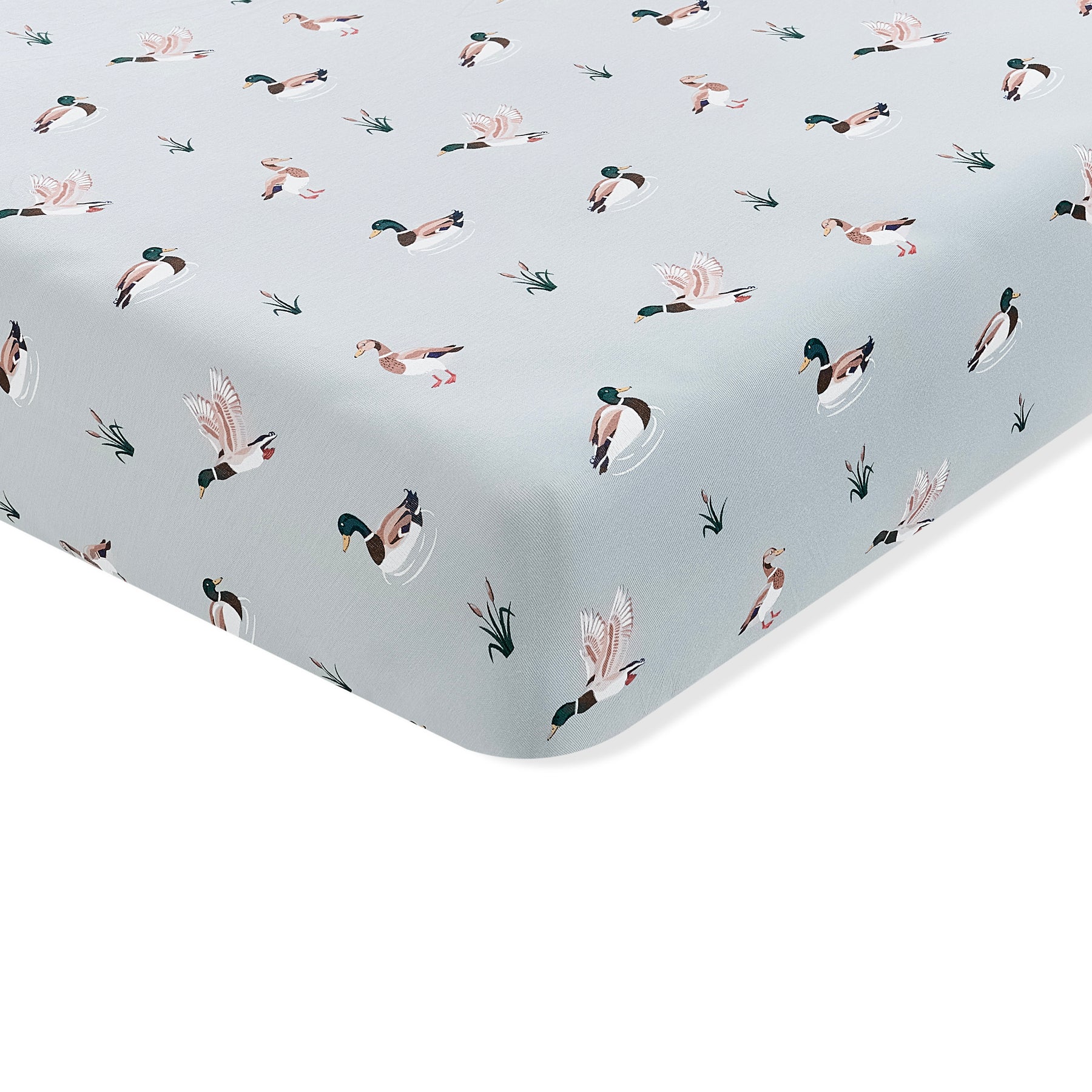 The corner of the Twin Sheet in Mallard Duck shown on a mattress