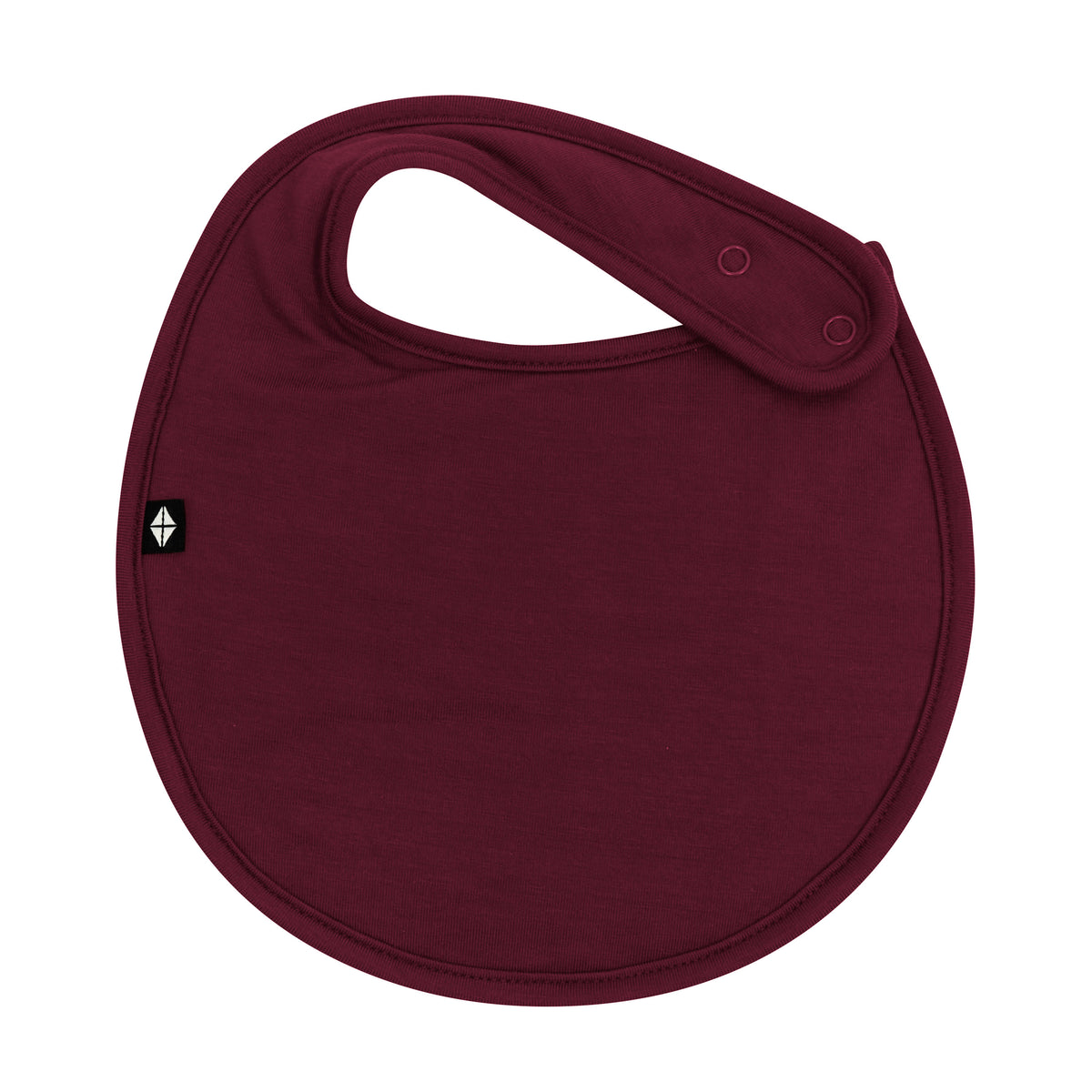 The front of the Cushy Bib in Burgundy showing the snap closures