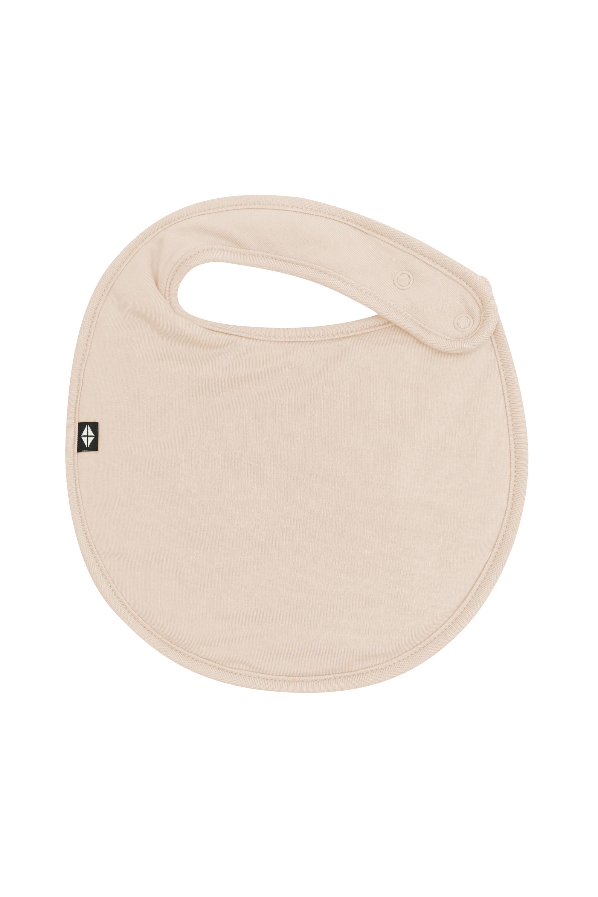 The front of the Cushy Bib in Bisque showing the snap closures