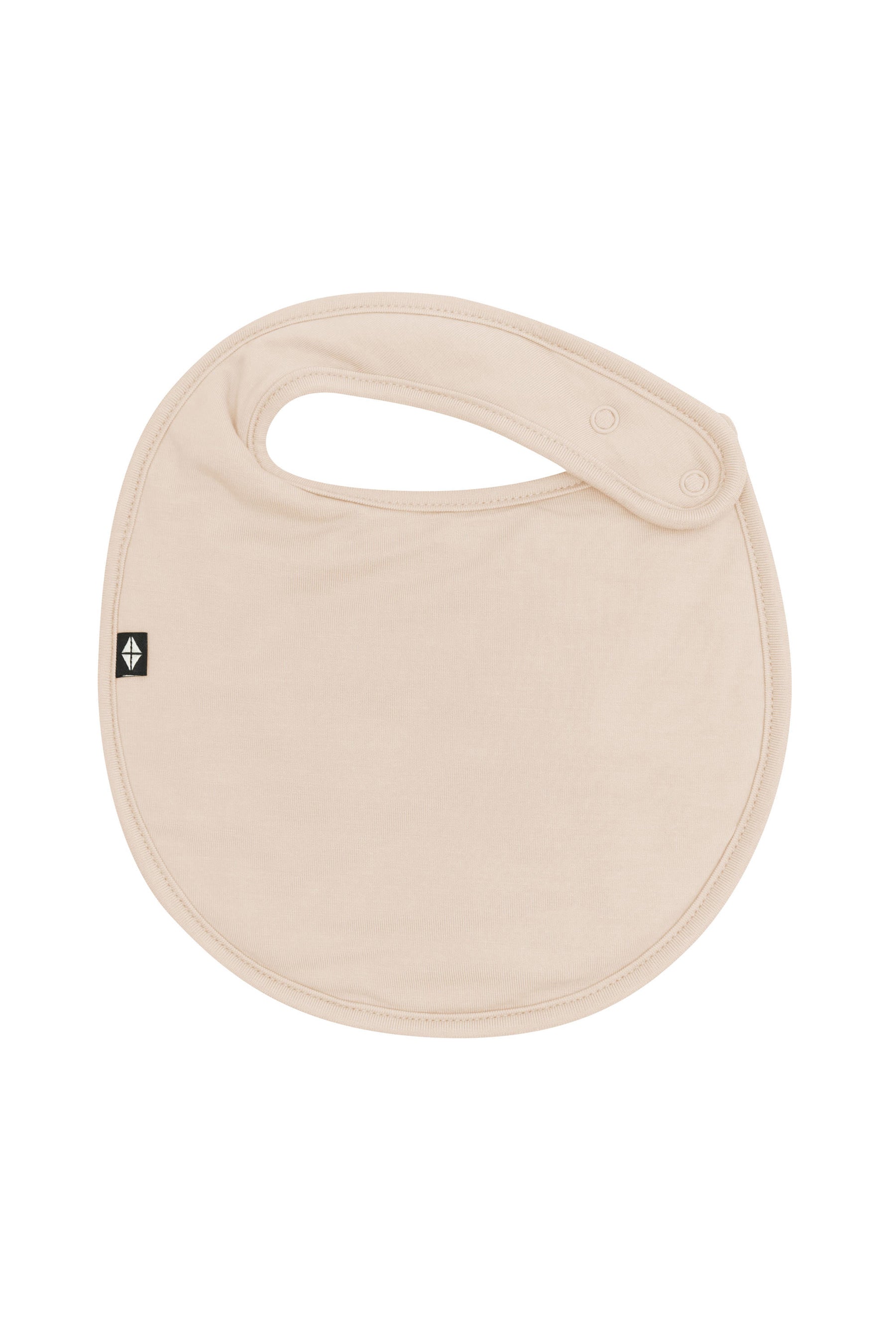 The front of the Cushy Bib in Bisque showing the snap closures
