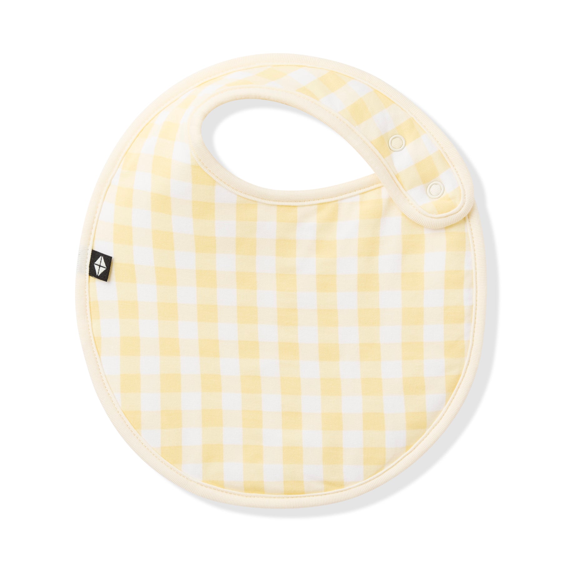 Front of the Cushy Bib in Gingham Chamomile with the snap closures visible