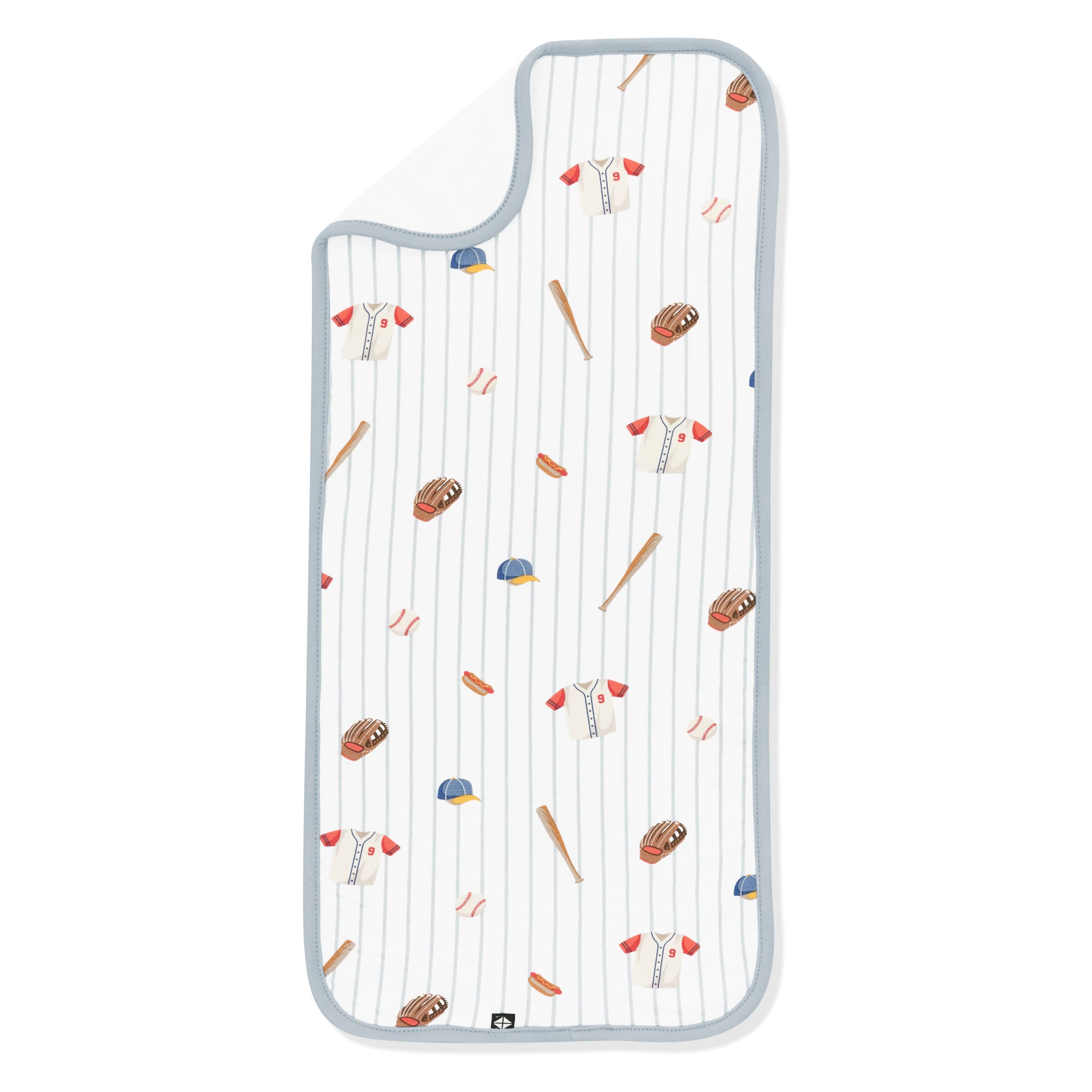 Burp Cloth in Home Run laid flat with the corner flipped down showing the bamboo terry cloth backing