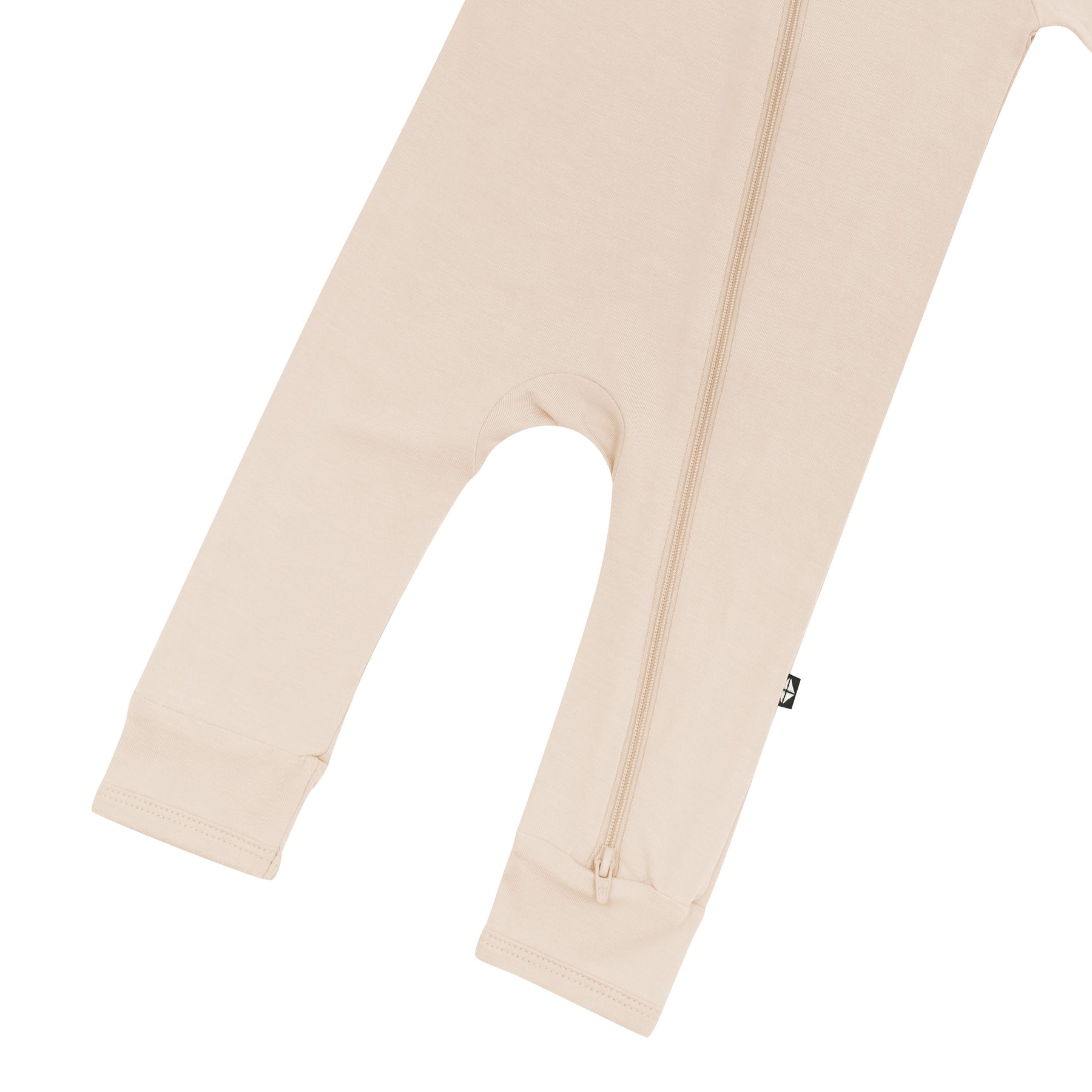 Bottom zipper shown on the leg of the Zippered Romper in Bisque