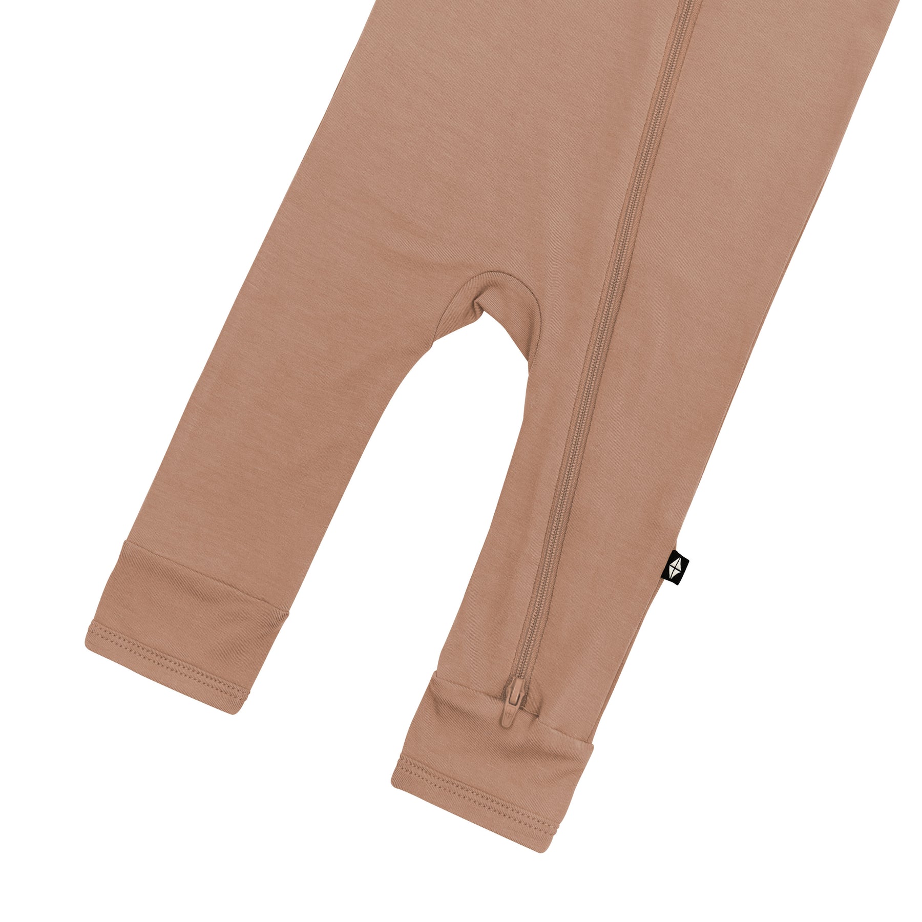 Bottom zipper shown on the leg of the Zippered Romper in Latte