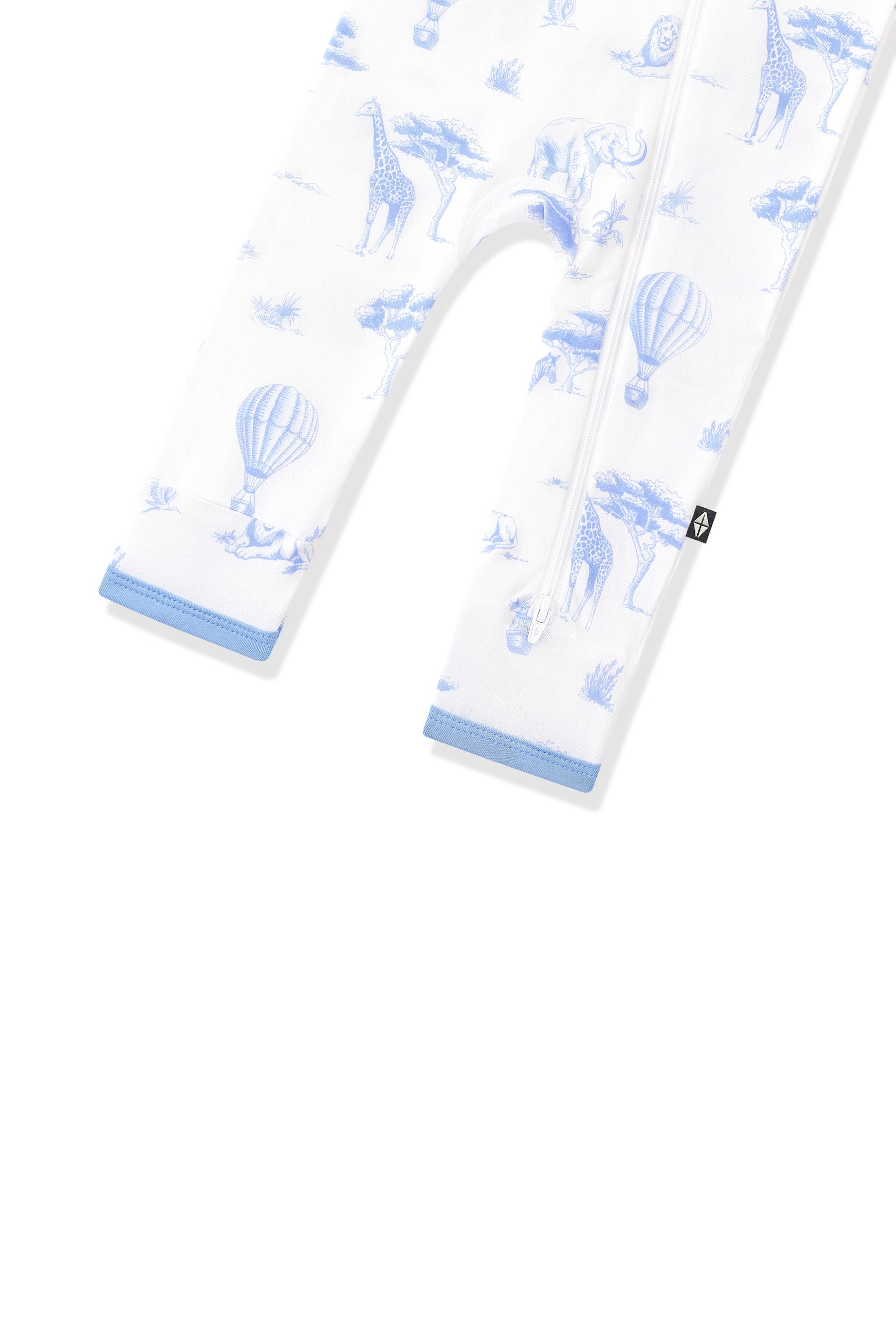 The zipper closure shown on the leg of the Zippered Romper in Toile Safari with the black kyte baby tag visible