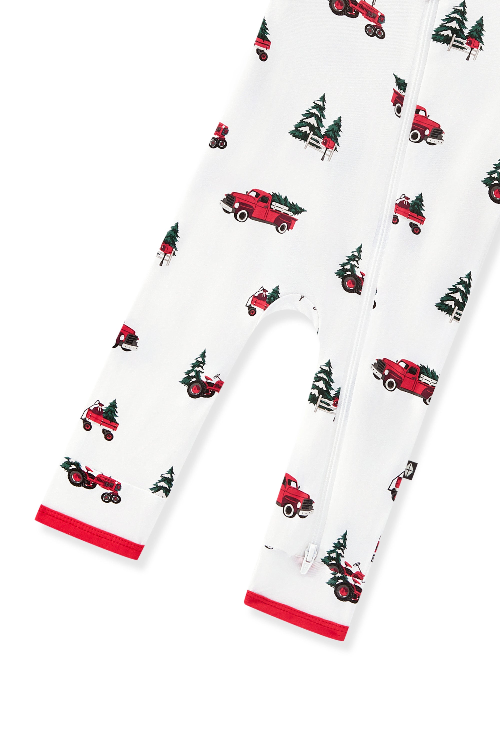 bottom part of White zippered romper with a red, green, and black Christmas truck and pine tree print, featuring red trim at the cuffs and a front zipper on a white background
