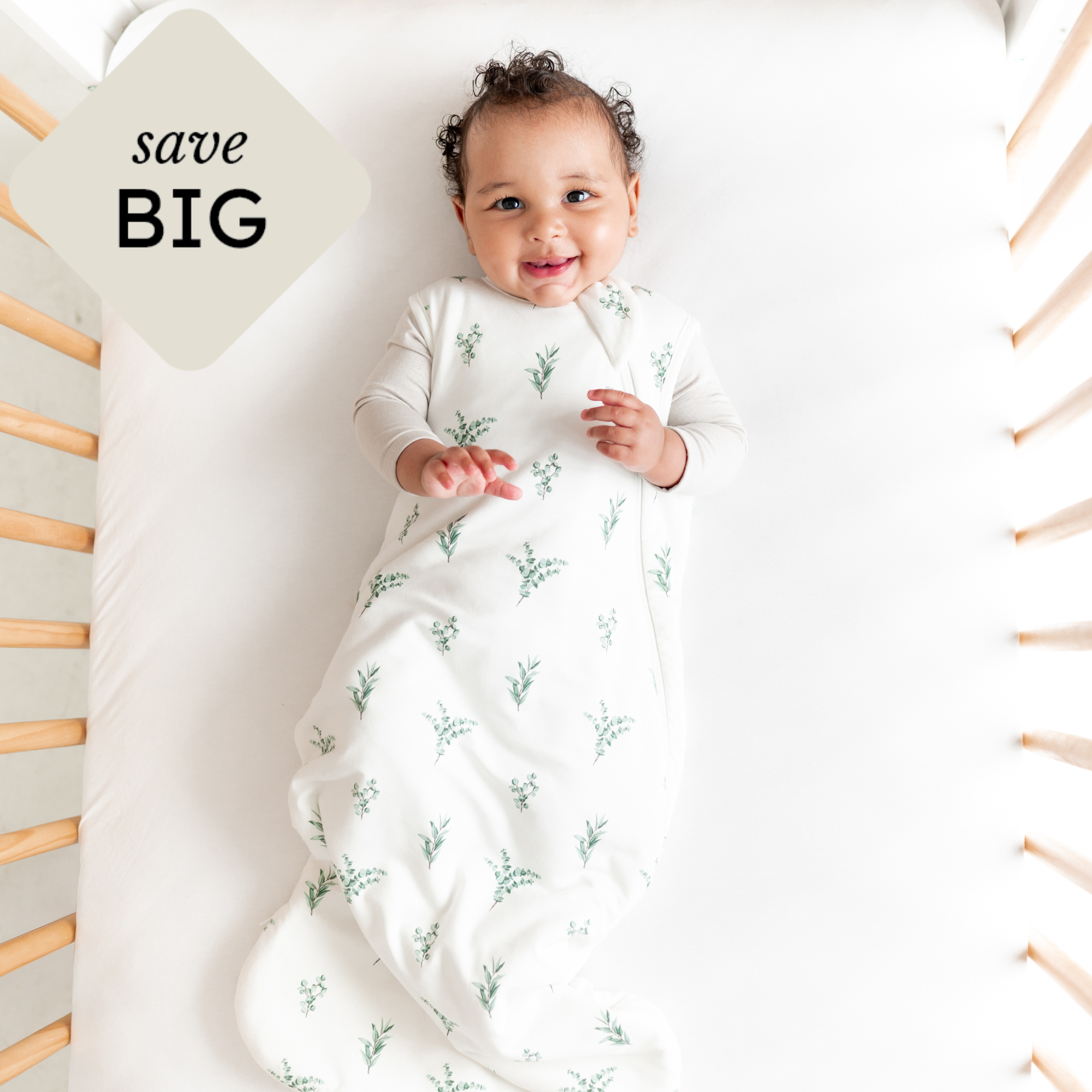 baby in eucalyptus sleep bag with save big icon