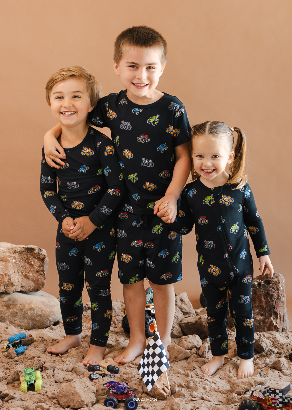 group of 3 kids in monster truck hot wheels by kyte baby collaboration printed pajamas 