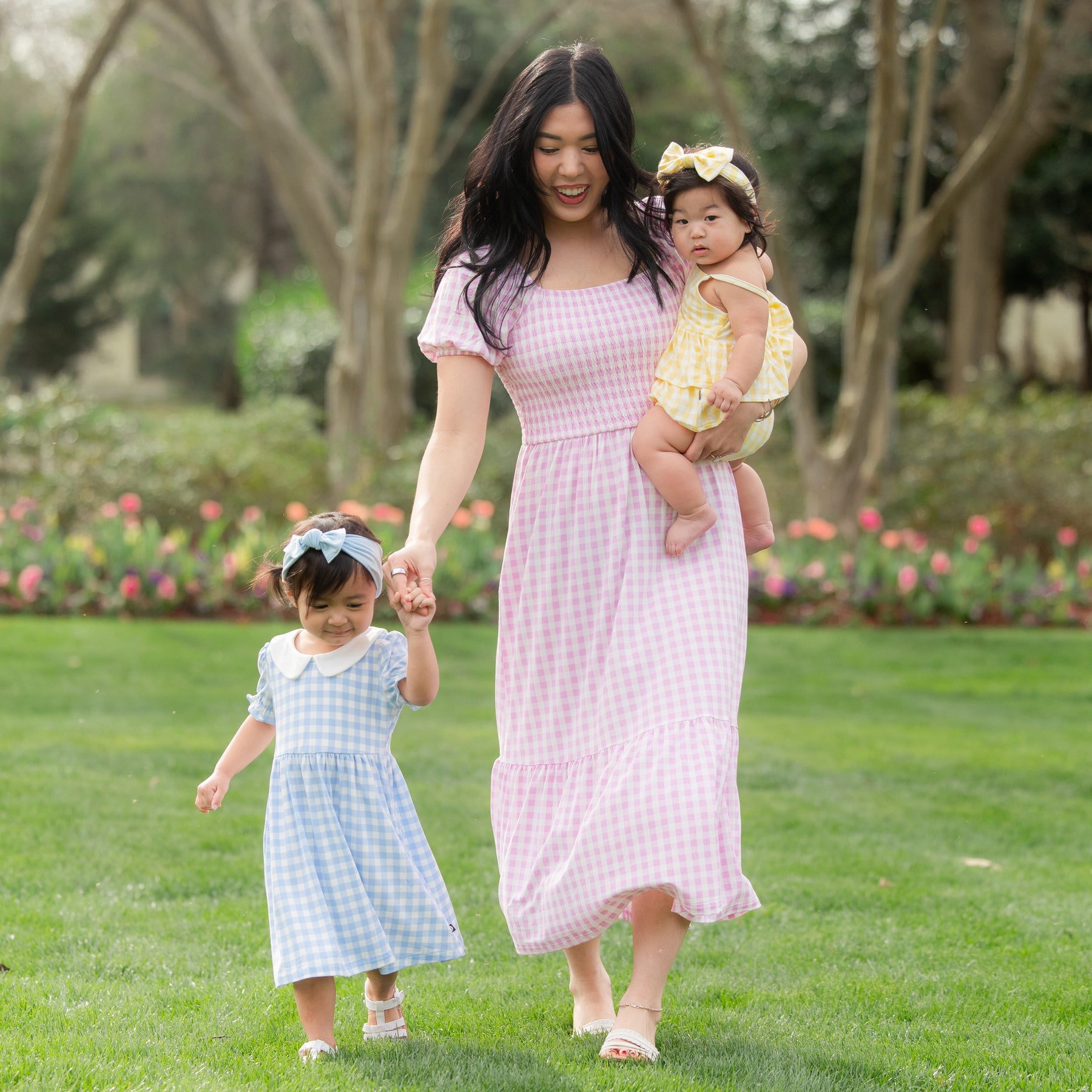Mother and two daughters wearing items from the Gingham Spring collection