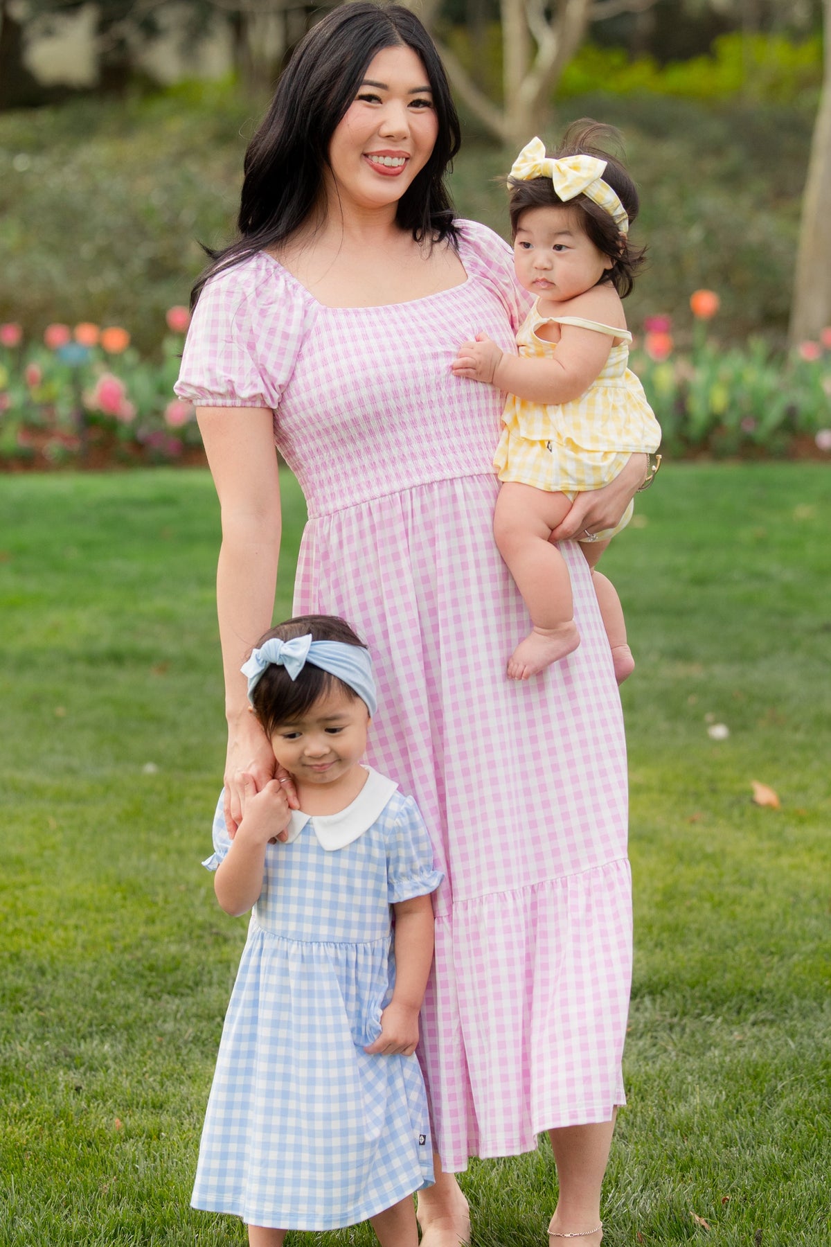 Mother and two daughters wearing dresses from the Spring Gingham Collection