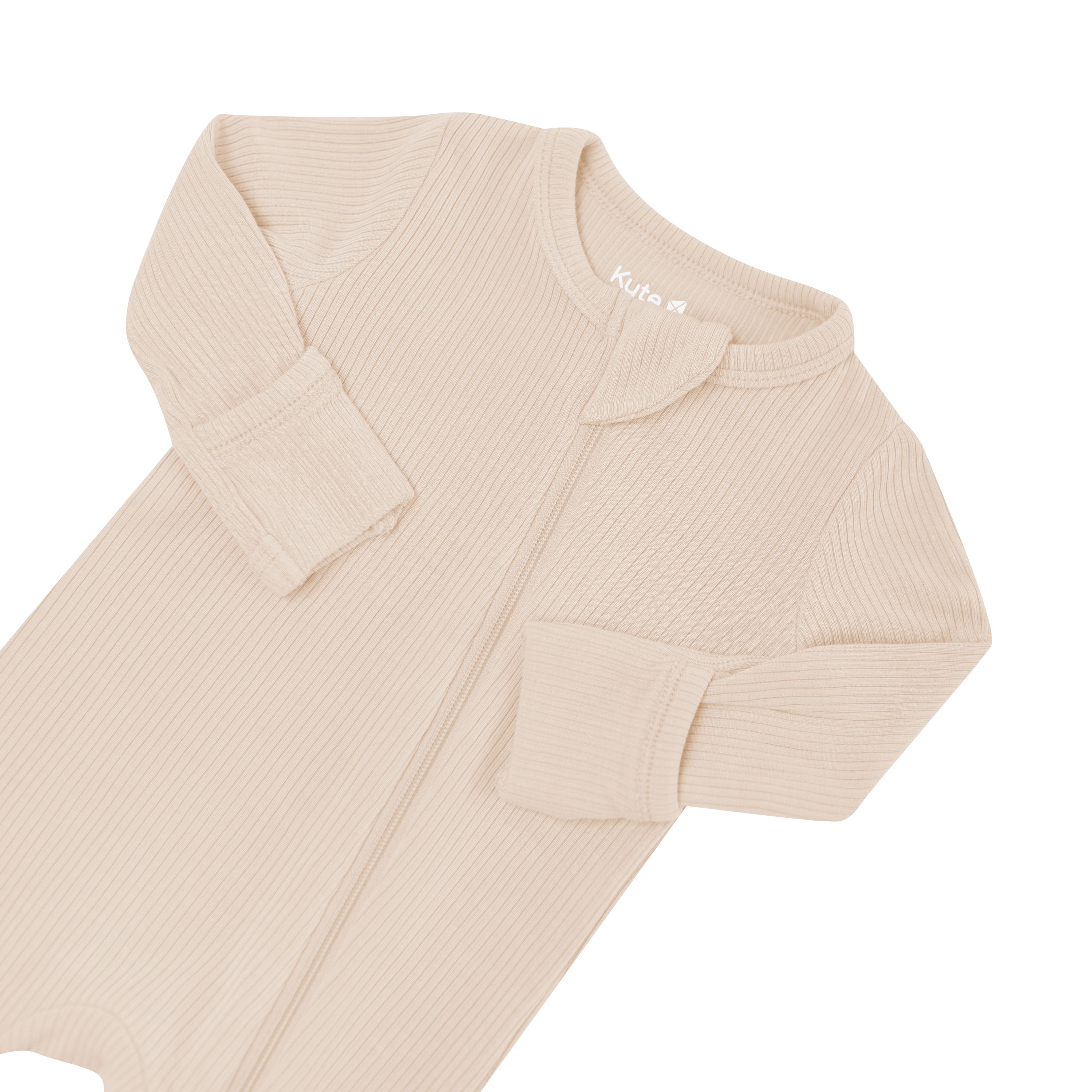 Close up photo of the zipper garage and fold over hand cuffs on the Ribbed Zipper Romper in Bisque