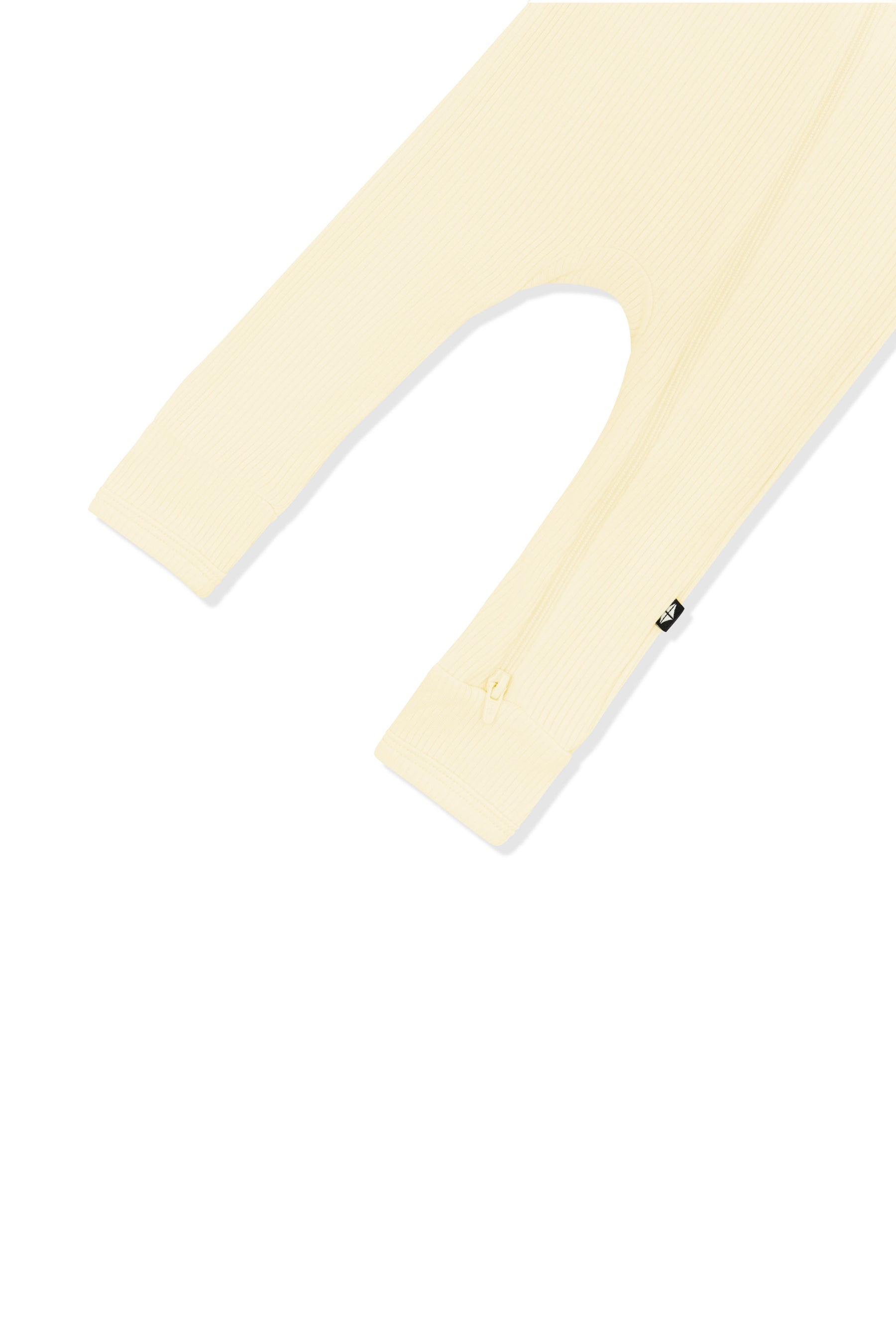 Close up of the zipper closure on the leg of the Ribbed Zipper Romper in Chamomile