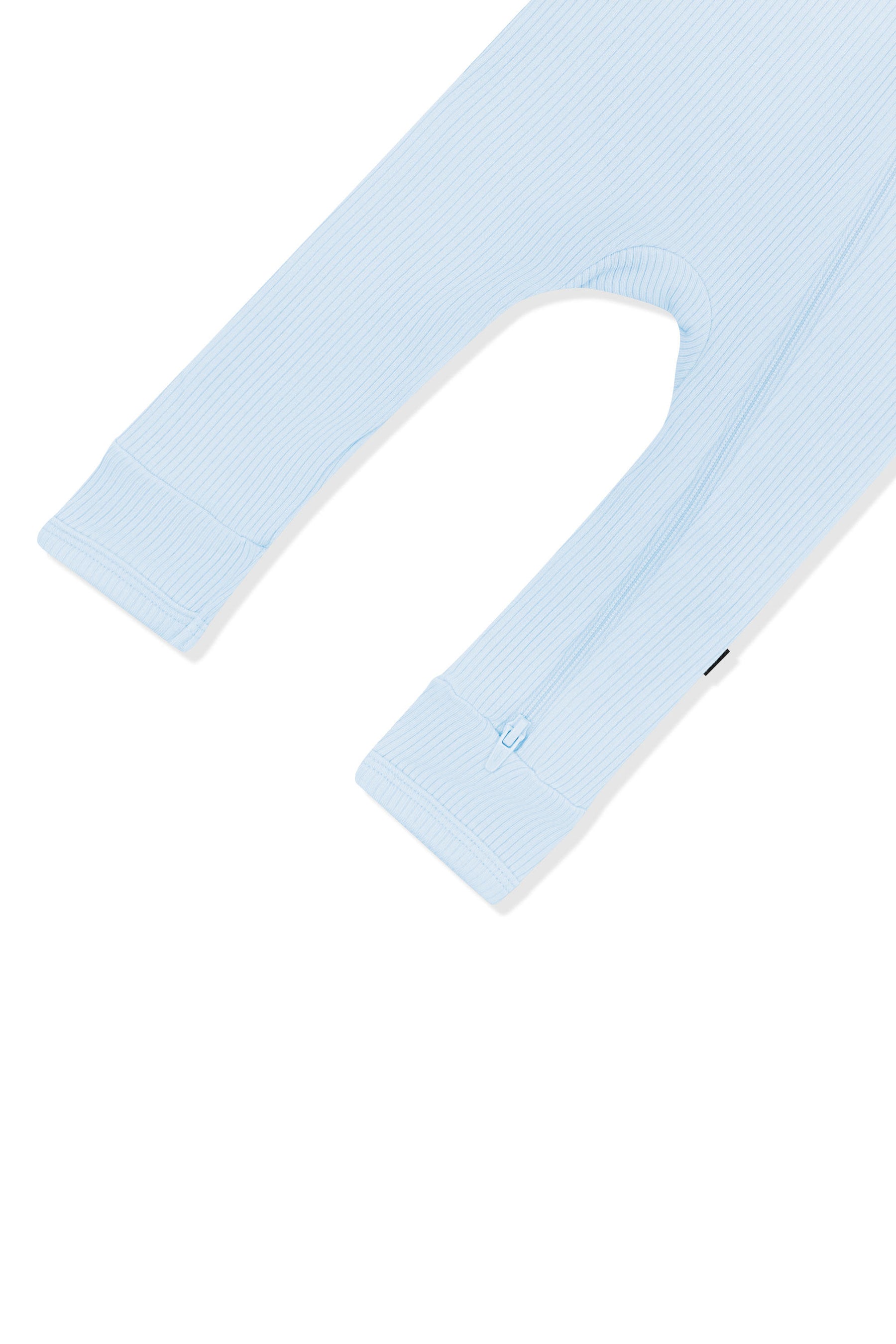 Close up of the zipper closure on the leg of the Ribbed Zipper Romper in Breeze