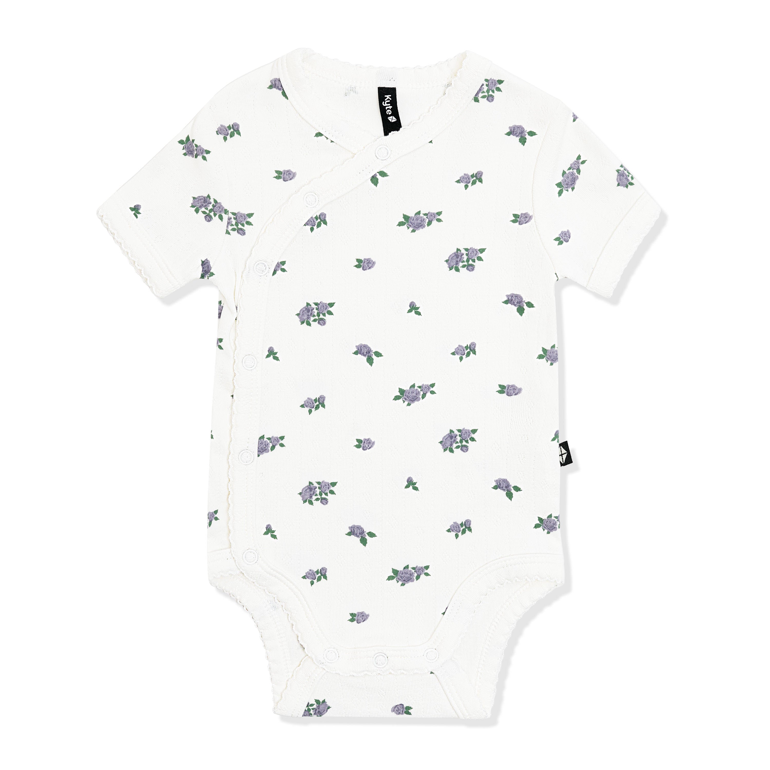 Pointelle Kimono Bodysuit in Spray Rose with the picot trim shown on the white surface