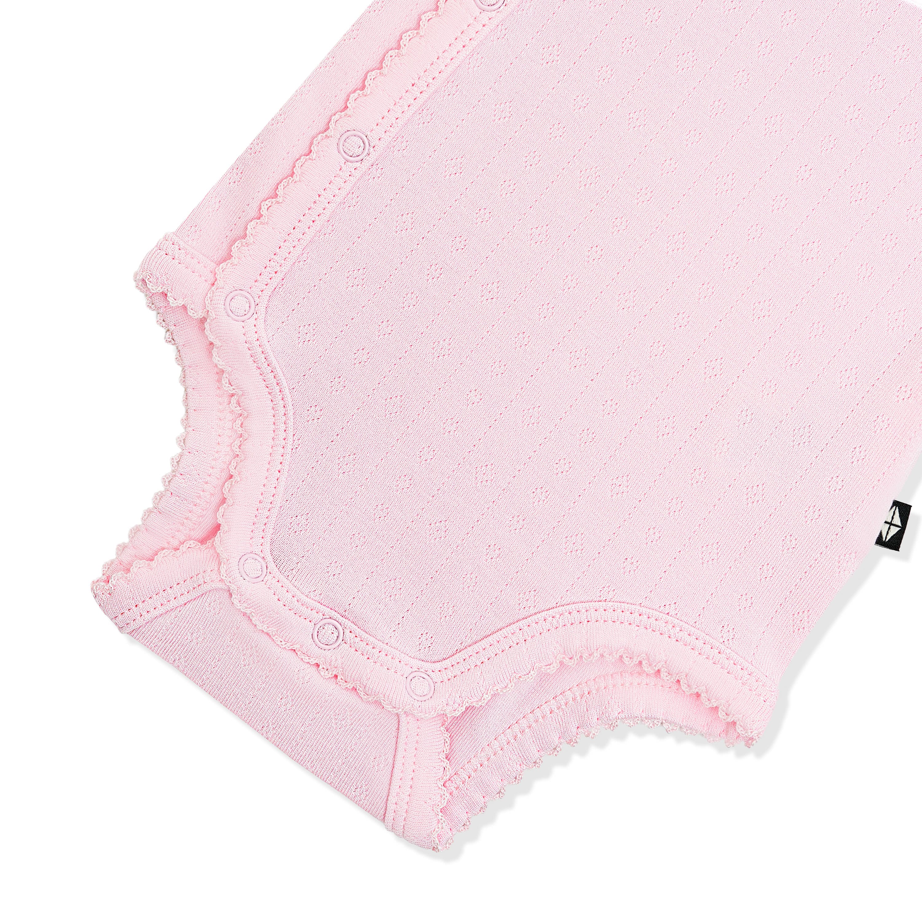 Snap closures and picot trim shown on the inseam on the Pointelle Kimono Bodysuit in Sakura 