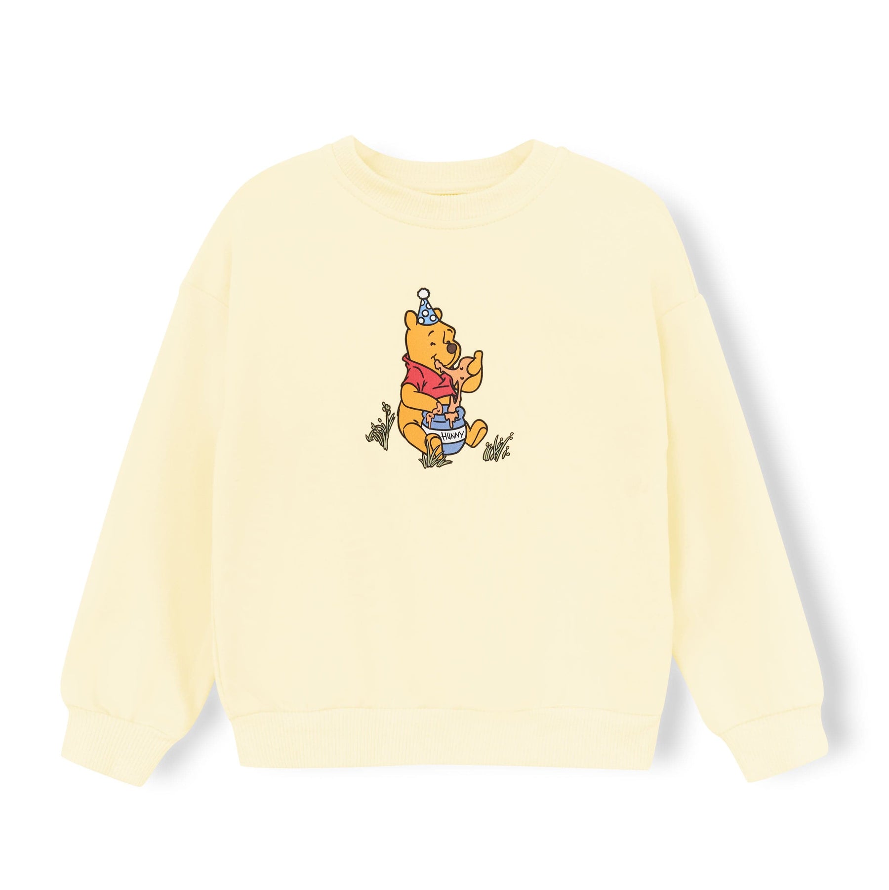 Light yellow sweatshirt with winnie the pooh in the center sitting on the ground eating honey for a honey pot