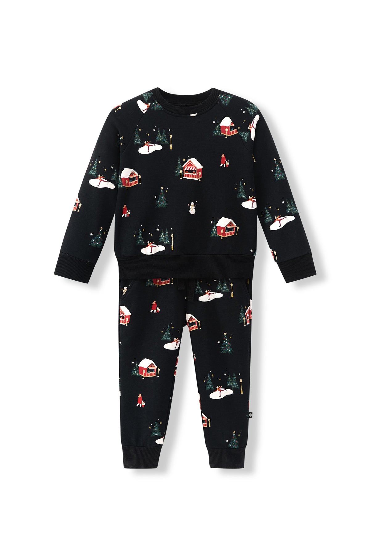 A two-piece kids' set featuring a long-sleeve top and matching pants in black, both printed with a winter holiday scene pattern of snow-covered cabins, evergreen trees, and snowflakes.