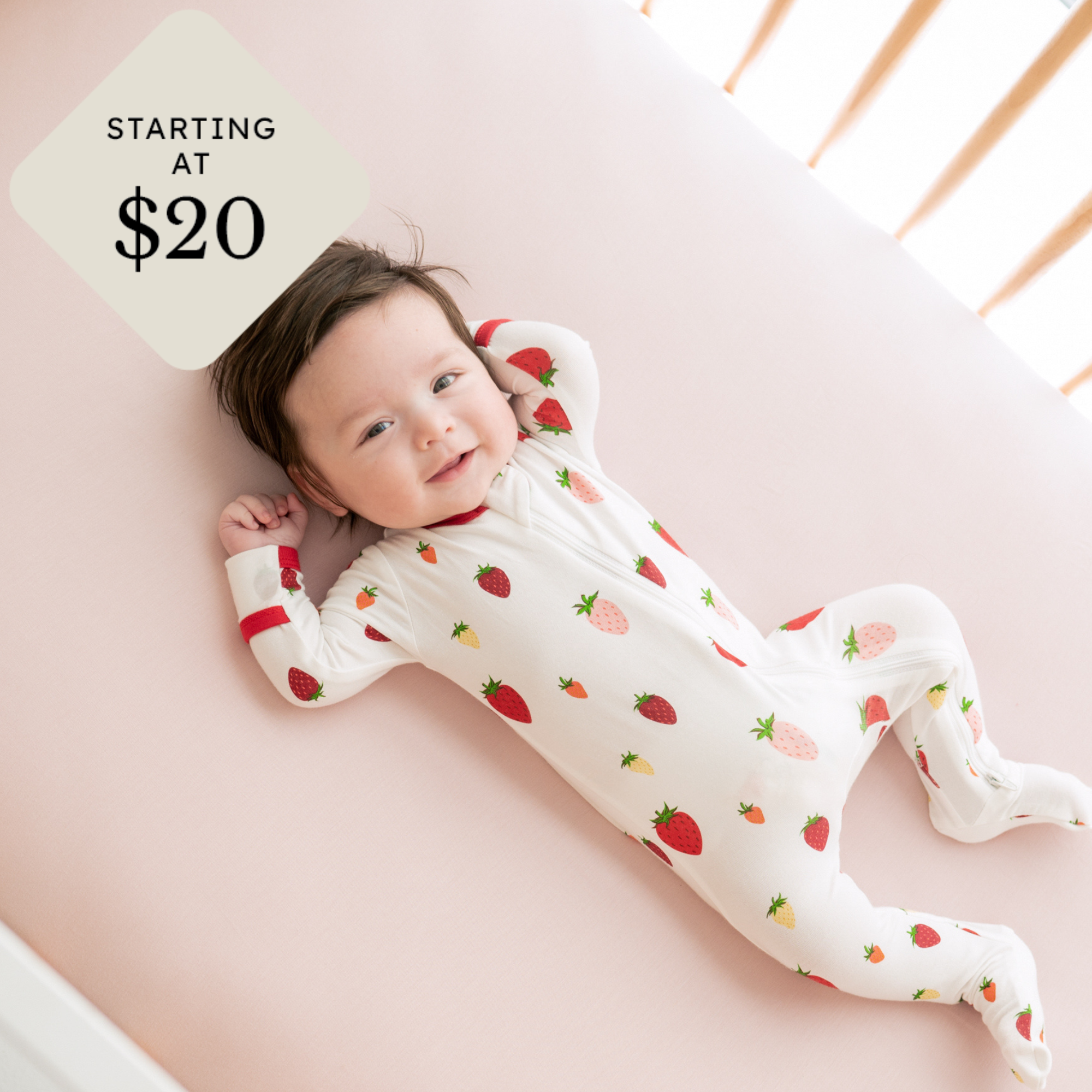 baby in strawberry footie with starting at $20 icon